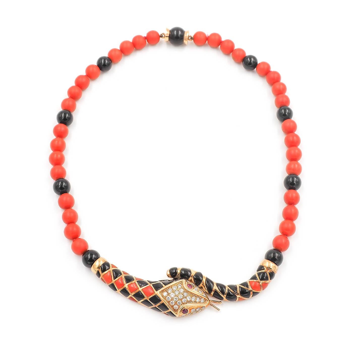 Vintage Coral & Onyx Snake Necklace composed of 18k yellow gold. With 32 Round Brilliant Cut diamonds set into the head (weighing approximately 0.64 carats in total), and 2 Round Cut natural ruby eyes weighing approximately 0.16 carats in total. The