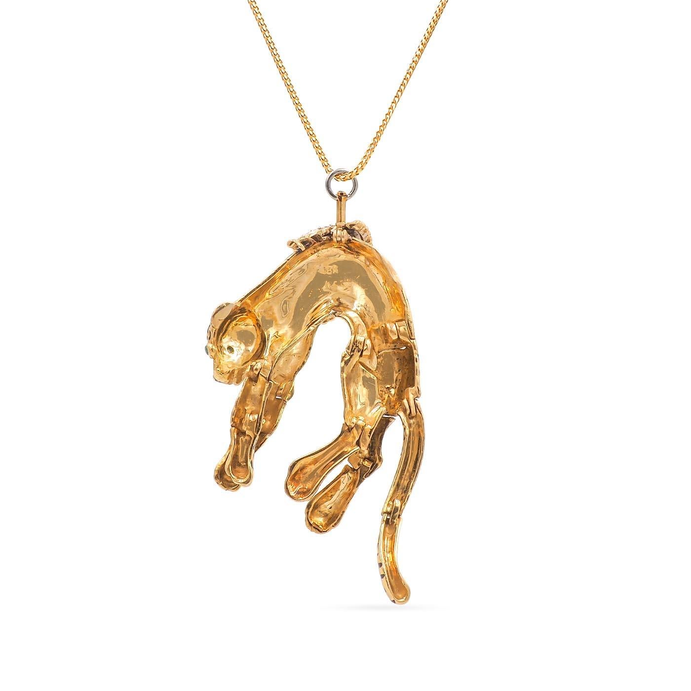 Vintage Panther Pendant Necklace composed of 18k yellow gold and platinum. The panther is laying draped over, with diamonds set at the center of the pendant, 16 Round Brilliant Cut diamonds weighing approximately 1.00 carats in total. With black