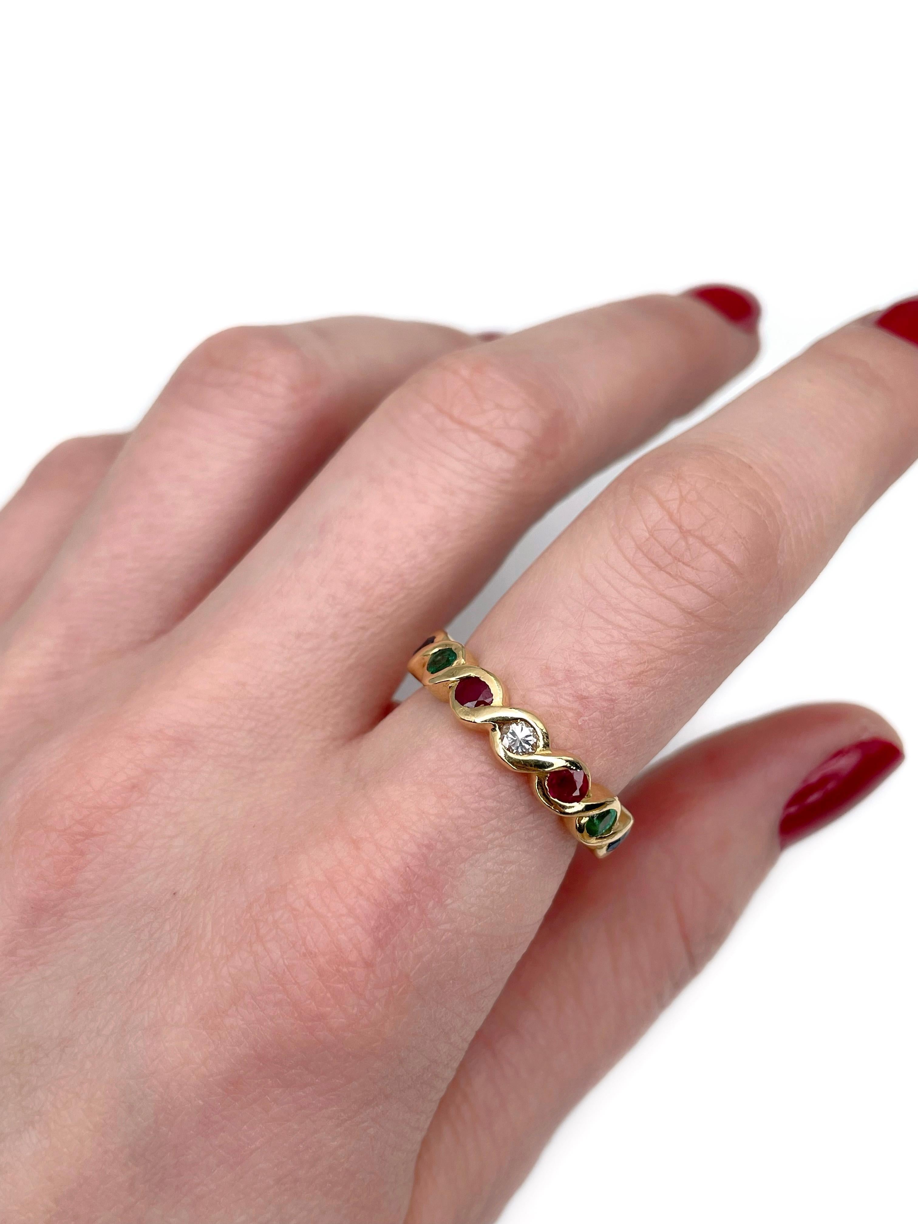 This is a vintage band main precious gem ring crafted in 18K yellow gold. Circa 1980. 

The piece features:
- 1 diamond, round brilliant cut, 0.10ct, STW, SI
- 2 emeralds, round cut, TW 0.24ct, vslbG 5/4, SI-P1
- 2 rubies, round cut, TW 0.35ct, slpR
