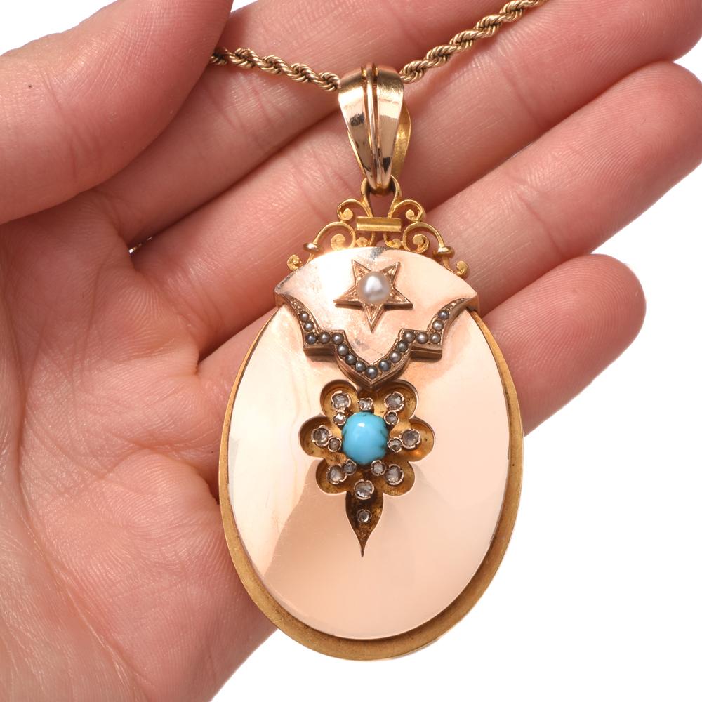 This vintage locket pendant of highly ornate aesthetic is crafted in a combination of 18 karat rose and yellow gold, weighing 29.5 grams and measuring 2.75
