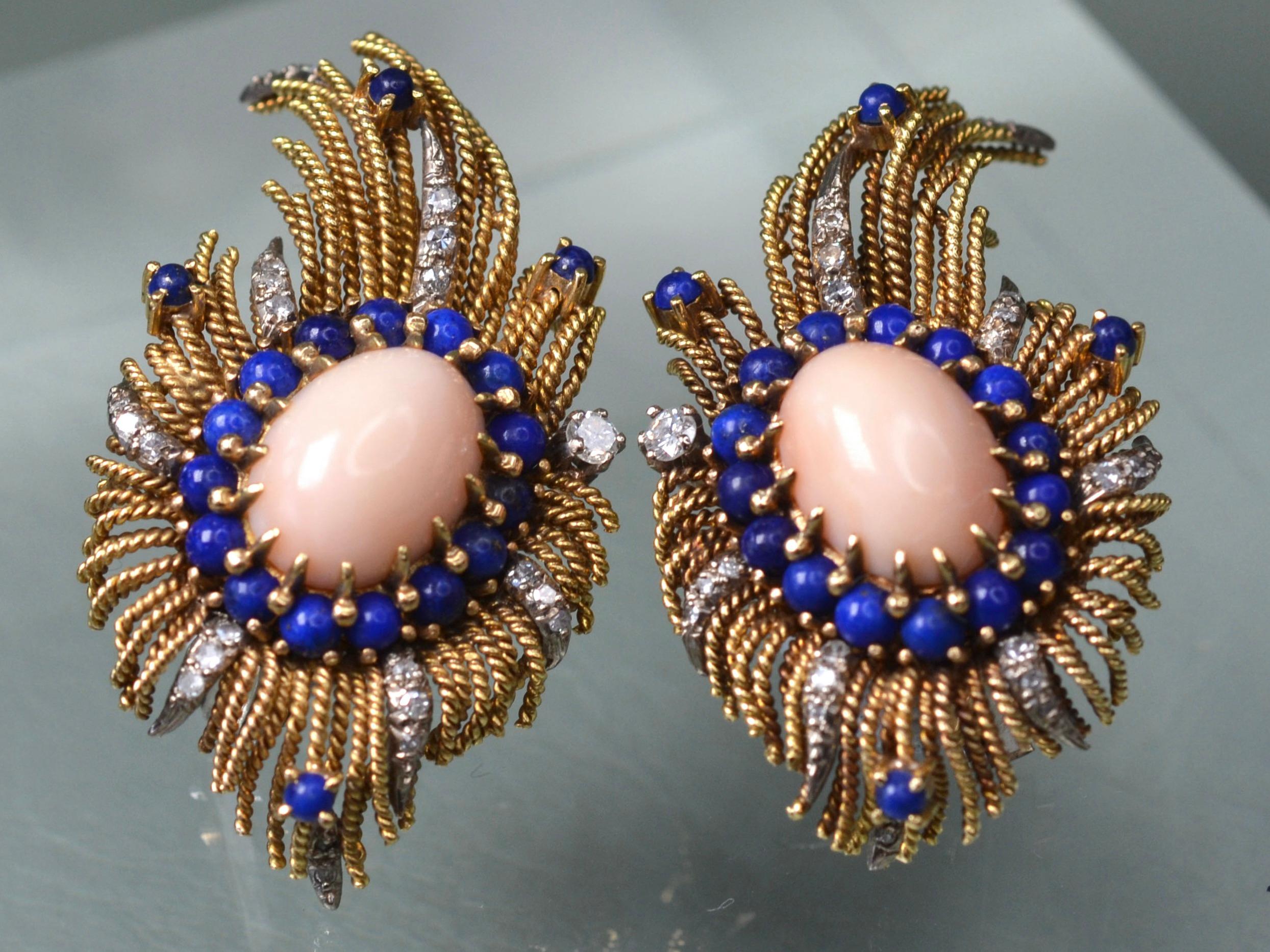 18 Karat Yellow Gold, large statement clip-on earrings from the 1970s.
Each earring features a central, pale pink 10mm x 15mm Coral stone, claw set in 18K Gold. Immediately surrounding each coral centrepiece are fifteen spherical, deep blue Lapis