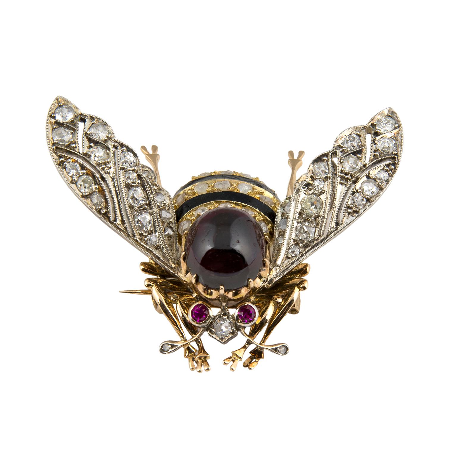 Vintage brooch in the shape of a bumblebee, in 18 Karat white gold-topped yellow gold, set with a garnet, black enamel, 1.60 carats in diamonds and two rubies.