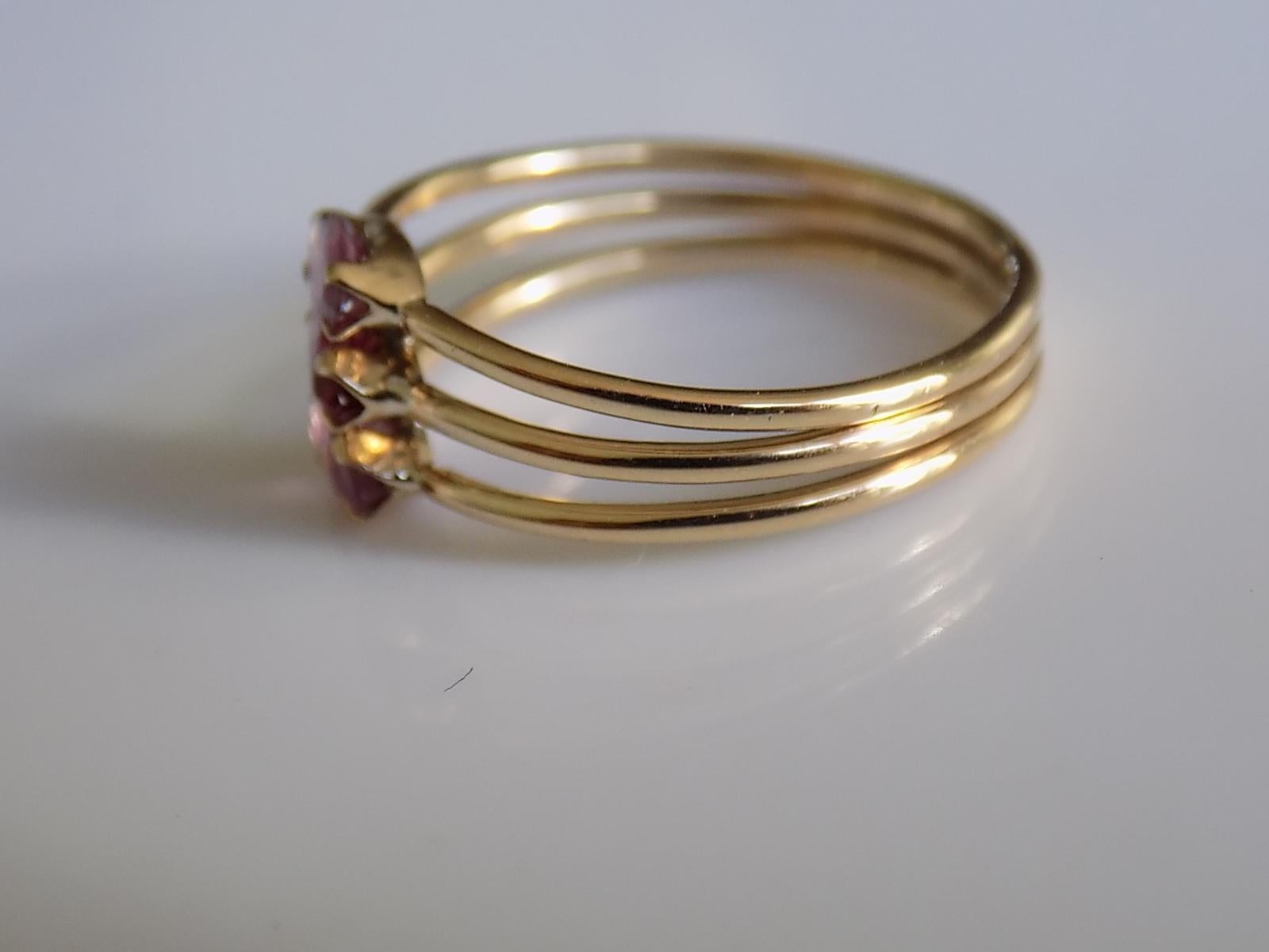 A Lovely Vintage 18 carat Gold and Marquise cut Garnet Harem style ring. Designed as three bands jointed together. 
Size L UK, 6 US.
Height of the face 8mm.
Weight 2.0gr.
Marked 18K for 18 Carat Gold.
Very good condition and ready to wear.