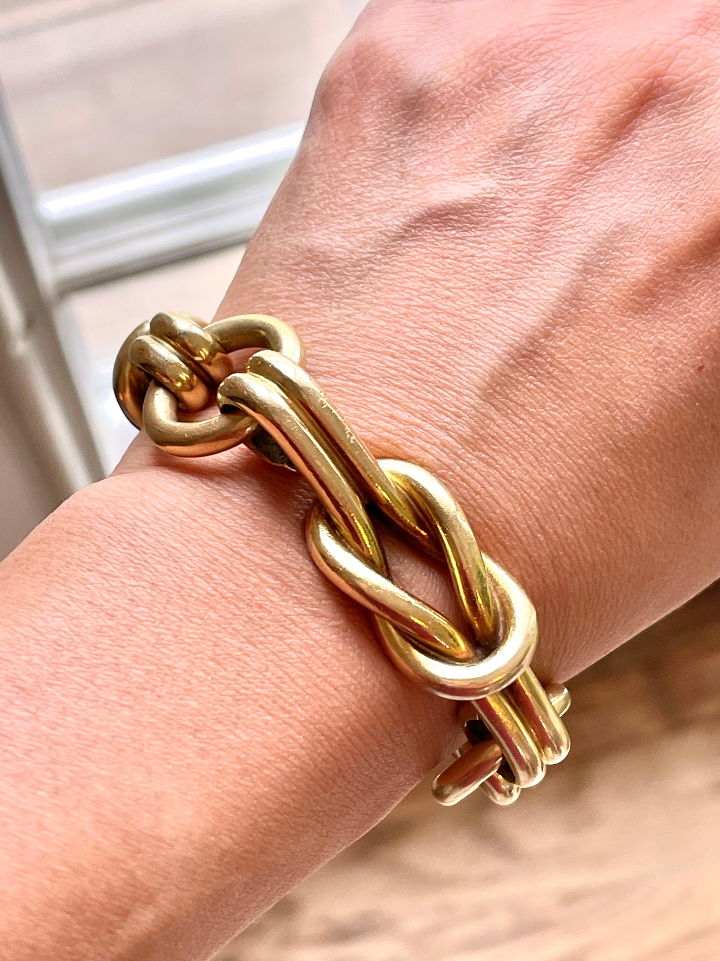 A vintage 18k yellow gold Hercules Knot bracelet by Gucci circa 1980. This gorgeous and heavy bracelet is a hollow form gold work of art. It depicts a Hercules Knot made of two ropes that symbolizes the strength of love and marriage. The knot was