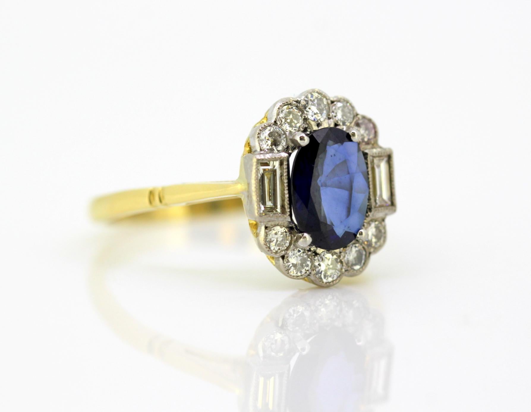 Vintage 18k yellow gold ladies ring with blue sapphire and diamonds
Circa 1970's
Hallmarked 18K

Dimensions -
Circa 1970's
Size : 2.5 x 2.2 x 1.3 cm
Weight: 4 grams total

Blue Sapphire -
Cut : oval
Size : 1.5 CT
Treatment : Natural

Diamonds - 
Cut