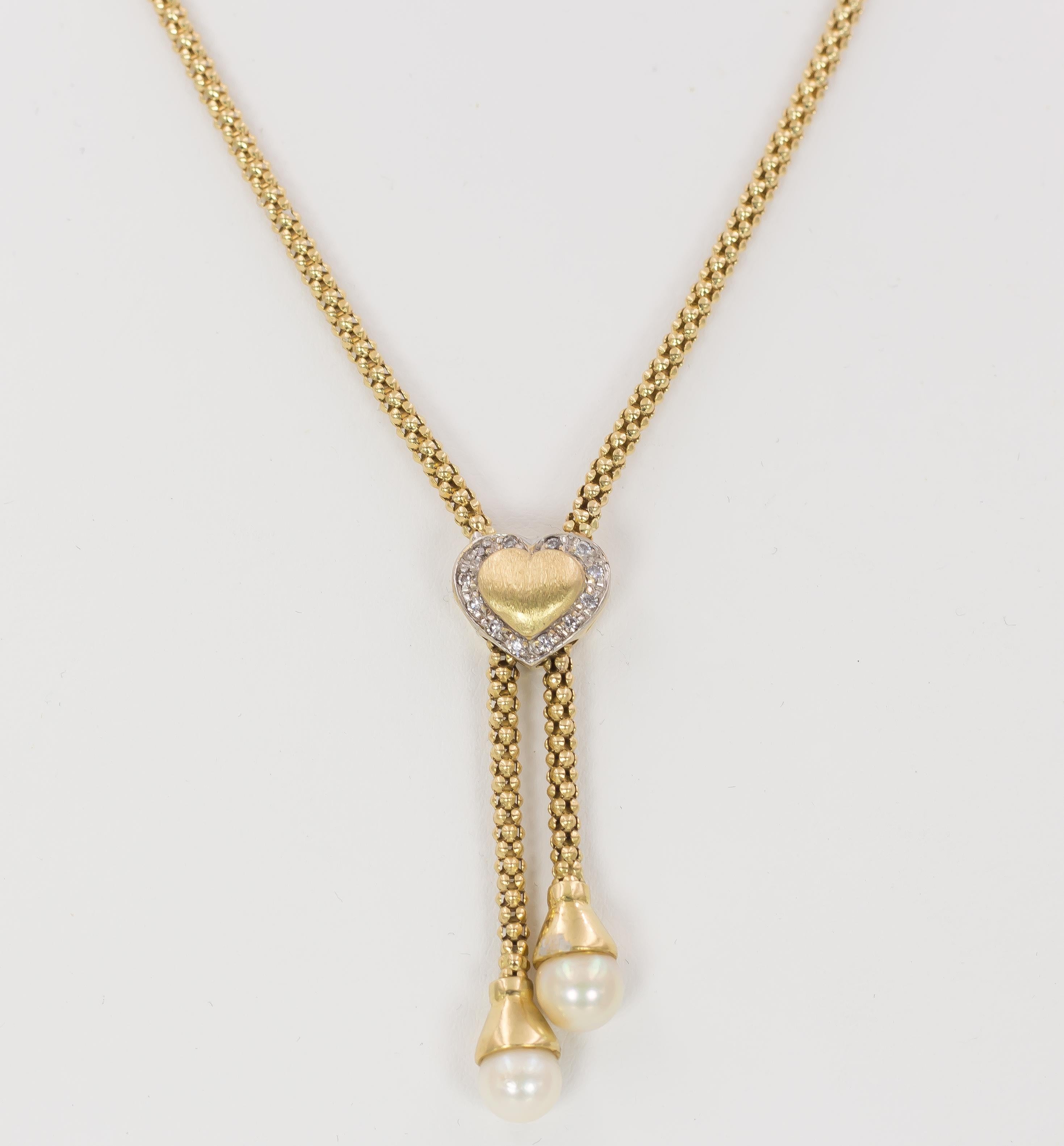 A lovely and fine vintage necklace, dating from the 1960s: the chain is crafted in 18K gold throughout and it is decorated with a central heart, that locks the chain; the heart is golden and its outer borders are decorated with zircons. The endings