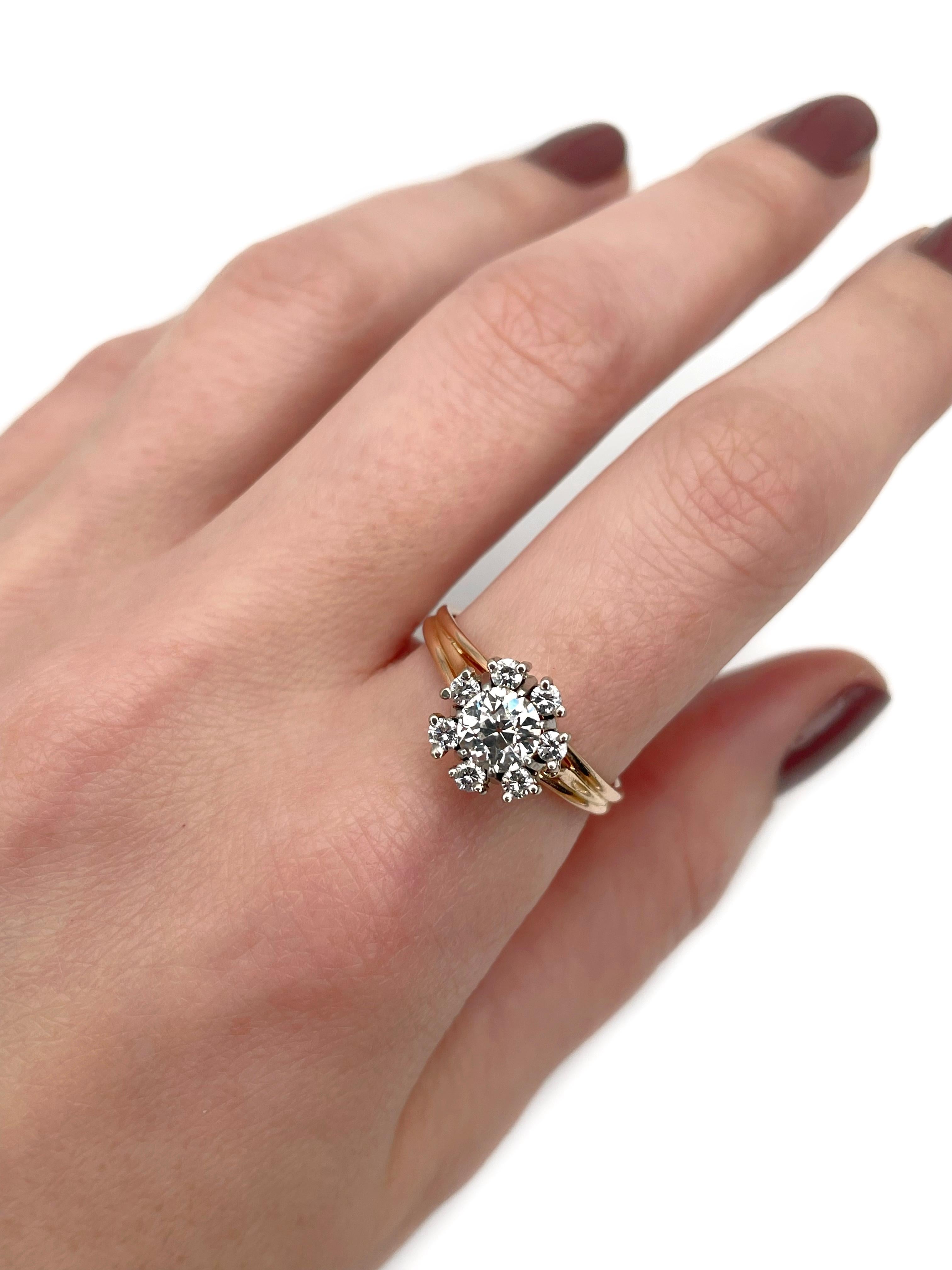 This is a vintage cluster ring crafted in 18K gold. Circa 1980. 

The piece features diamonds (TW 0.84ct):
- 1 diamond, old European cut, 0.60ct, W-STW, VS
- 7 diamonds, round brilliant cut, TW 0.24ct, W-STW, VS-SI

Weight: 4.24g
Size: 18.5 (US