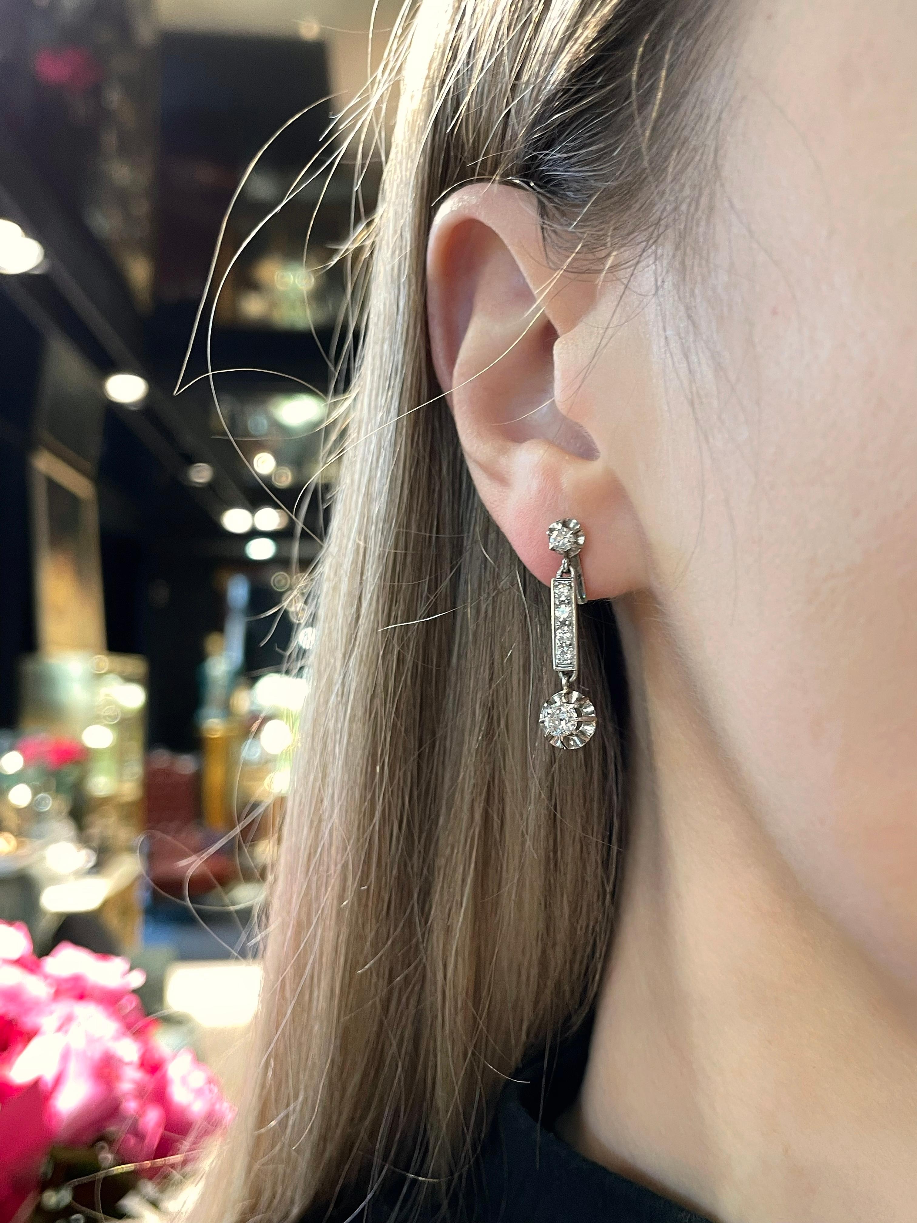 This is a pair of vintage drop stud earrings crafted in 18K gold and 900 platinum. Circa 1960.

The piece features diamonds (TW 0.92ct):
- 2 old European cut, TW 0.50ct, RW-W, VS
- 2 old European cut, TW 0.16ct, RW-W, VS-SI
- 8 round brilliant cut,