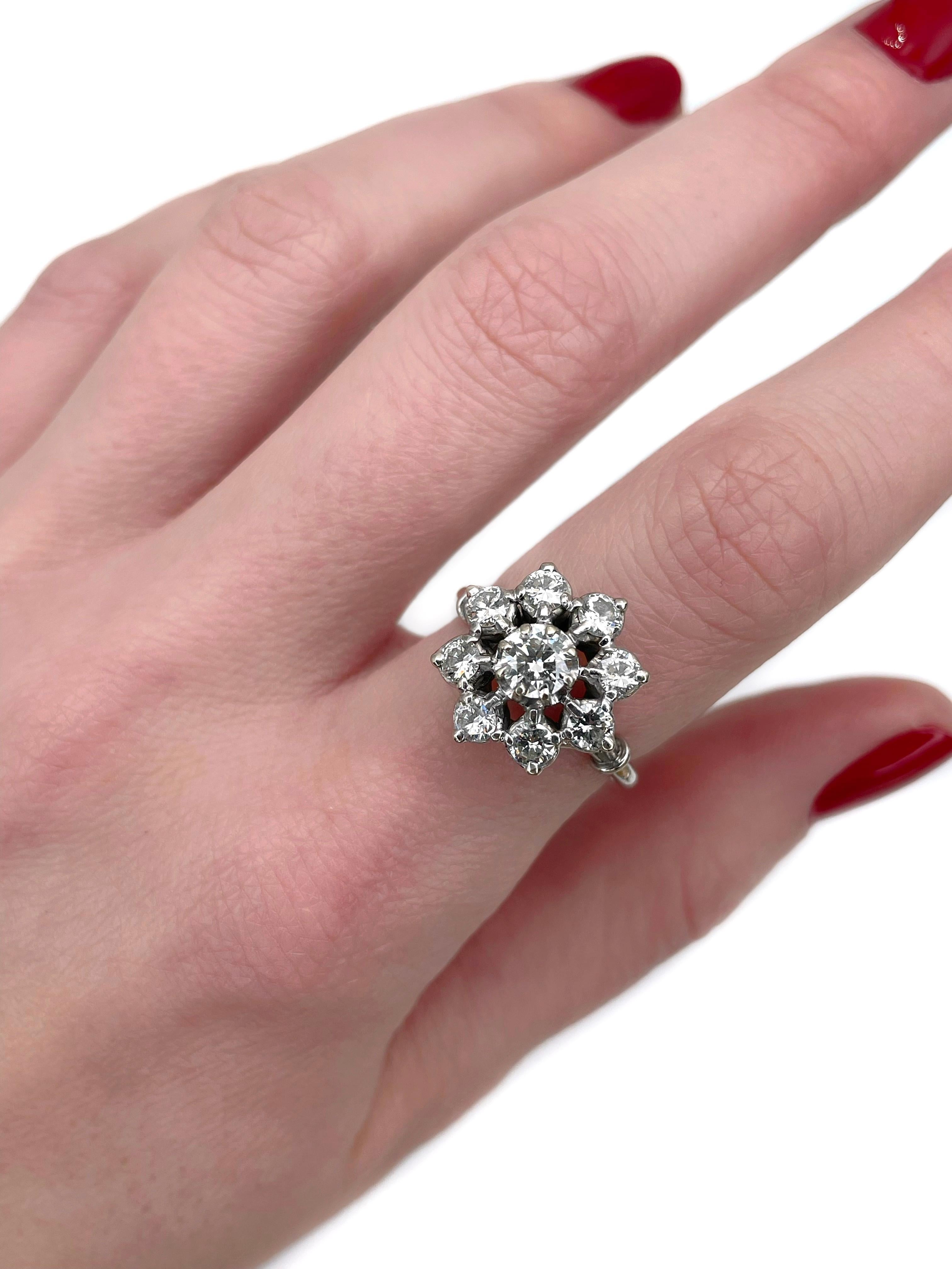 This is a vintage cluster ring crafted in 18K white gold. Circa 1970. 

The piece features diamonds (TW 1.40ct):
- 1 diamond ( round brilliant cut, 0.40ct, RW-W, SI2)
- 8 diamonds (round brilliant cut, TW 1.00ct, RW+/W, VVS-VS)

Weight: 5.50g
Size: