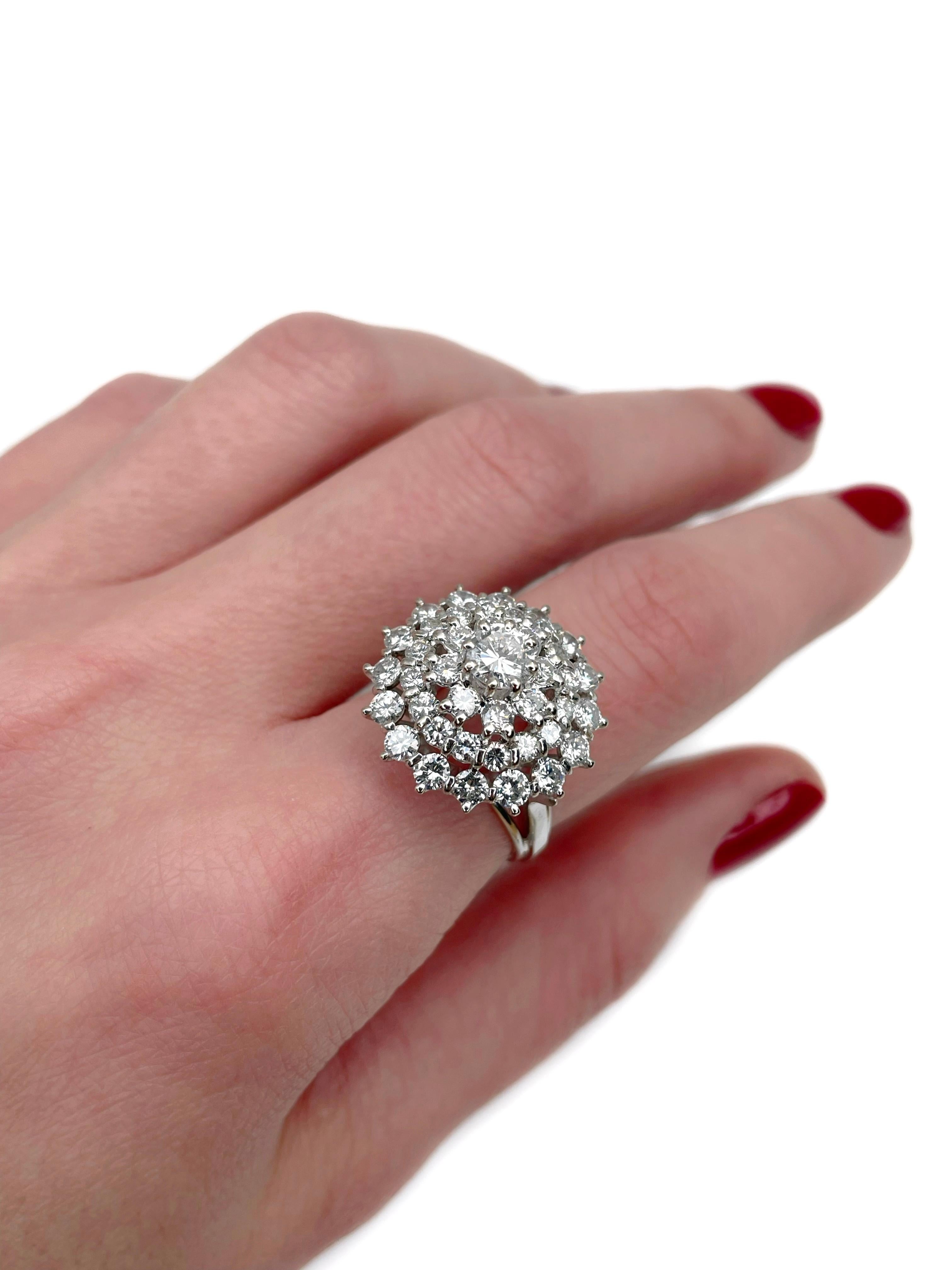 This is a vintage cocktail ring crafted in 18K white gold. Circa 1980. 

The piece features diamonds (TW 2.95ct):
- 1 diamond (round brilliant cut, 0.45ct, RW-W, SI)
- 40 diamonds (round brilliant cut, TW 2.50ct, RW-W, VS-SI)

Weight: 6.68g 
Size: