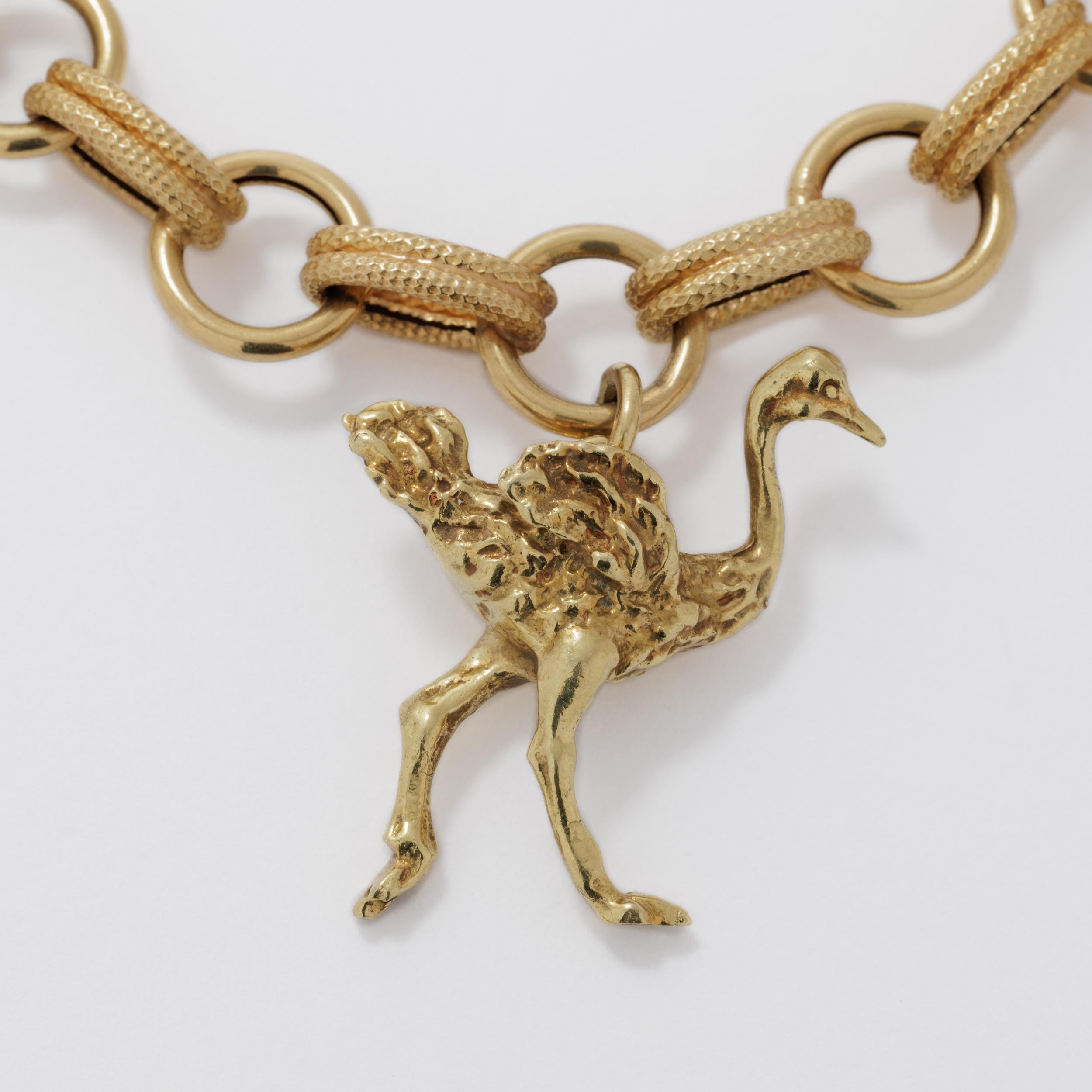 Vintage 18 Karat RARE African Souvenir Charm Bracelet featuring an extra large Giraffe, extra large Ostrich and a Map of Africa 
- all solid 18 Karat Gold 
c.1950s 

L 21.5 cm x 1.1 cm / 8.46 in. x 0.43 in.
Africa 2.6 cm x 2 cm / 1.02 in. x 0.79
