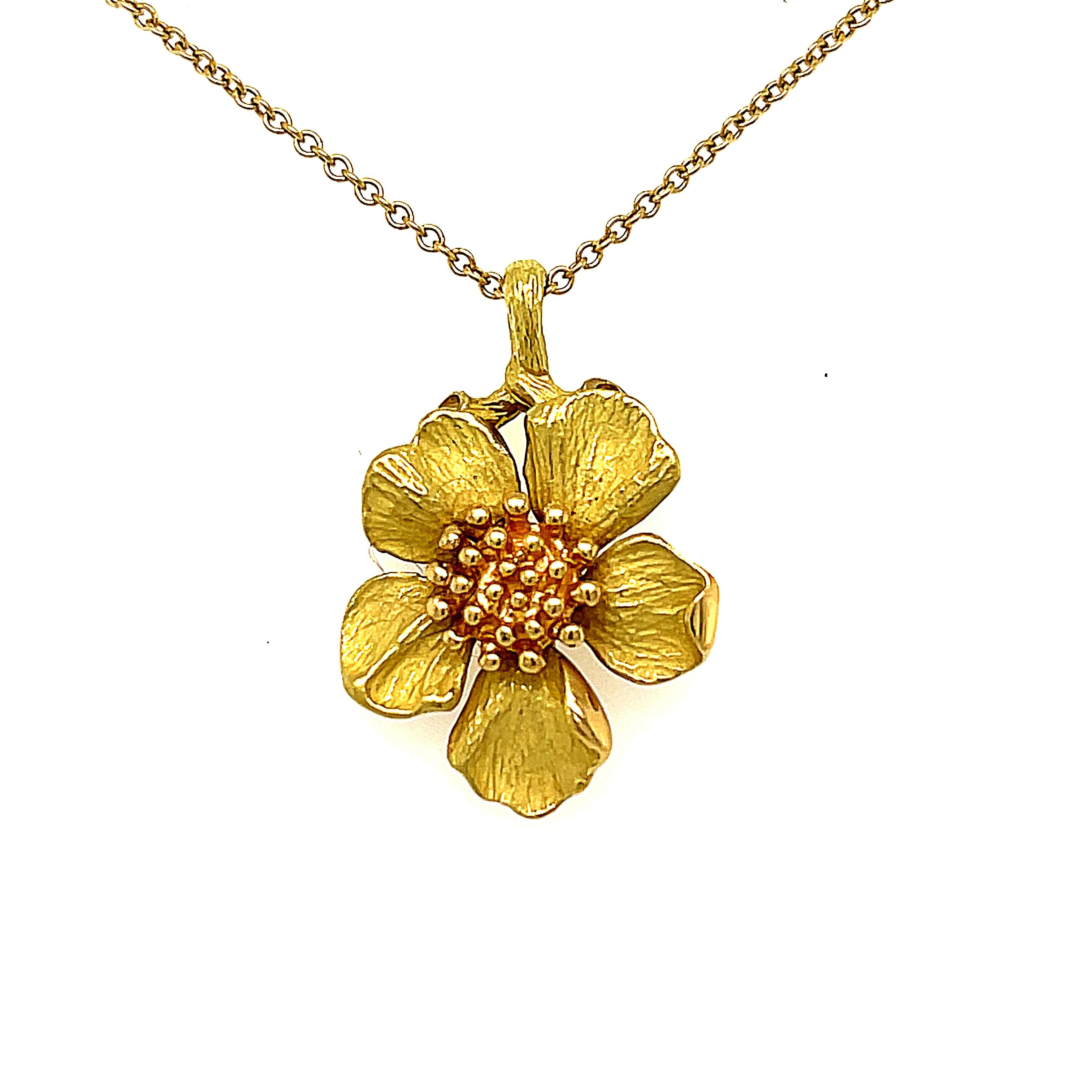 A vintage 18K Tiffany Dogwood Necklace and Earrings set, circa 1980. The earrings are a classic single dogwood flower shape, that is for pierced ears. The pendant is the same shape on a thin chain that is 16 inches long. Both the earring and the