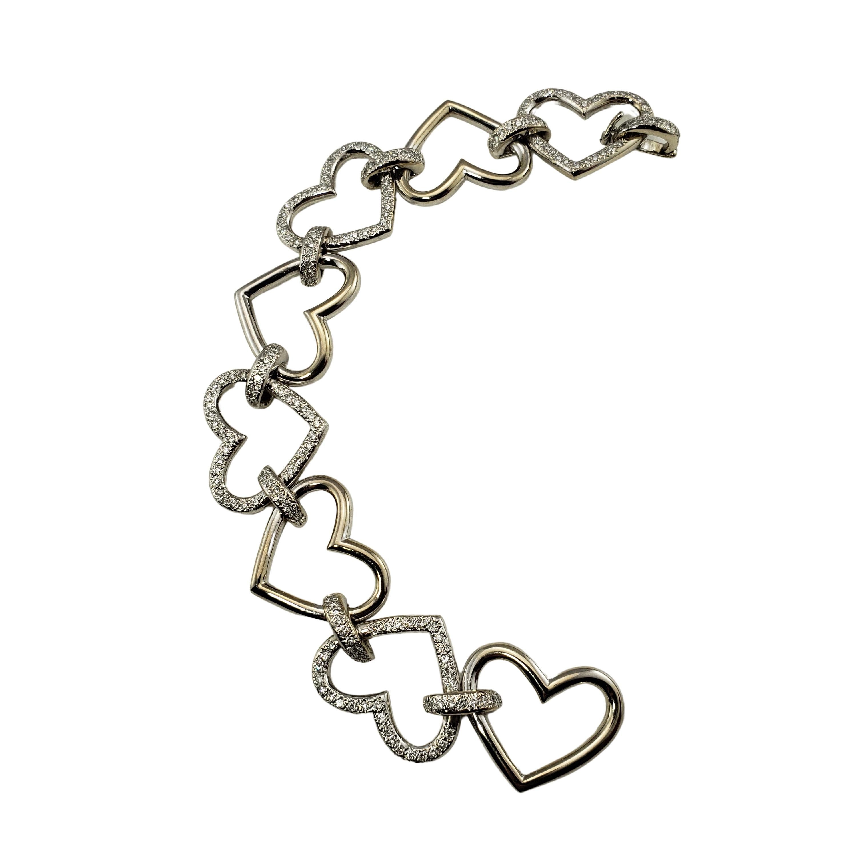 Vintage 18 Karat White Gold and Diamond Heart Link Bracelet-

This sparkling heart link bracelet features 192 round brilliant cut diamonds set in classic 18K white gold.  Width:  19 mm.

Approximate total diamond weight:  2 ct.

Diamond color: 