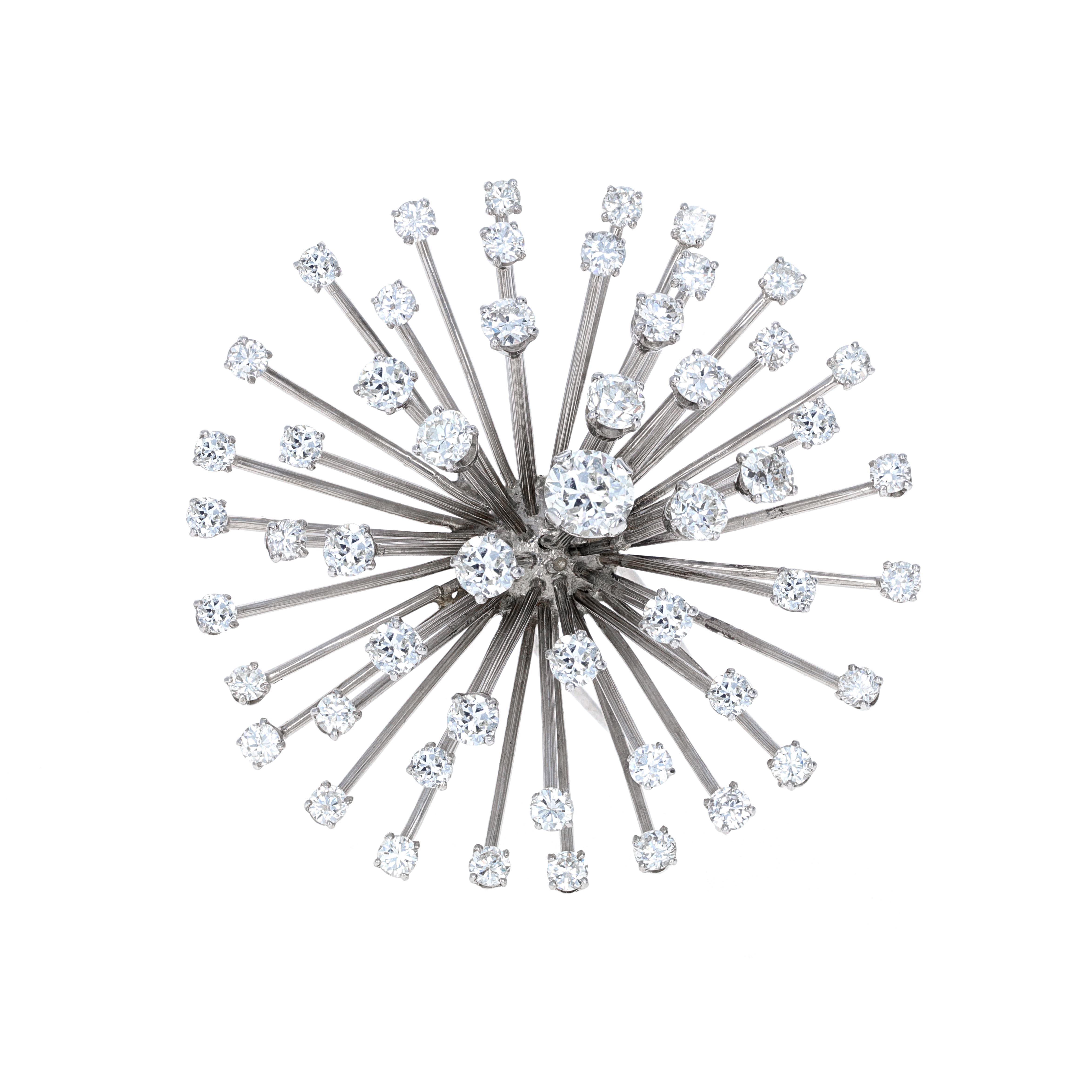 Vintage 18 karat white gold diamond firework brooch. The diamonds are white in color and eye clean. The center stone weighs 1.03 carats.


