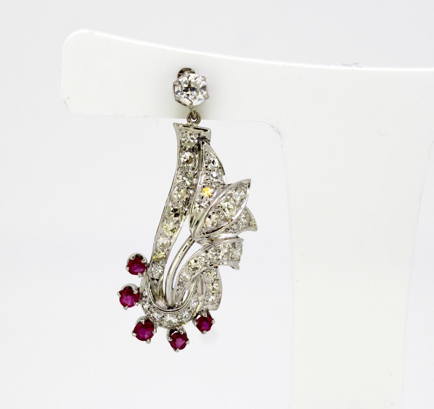 Vintage 18k white gold ladies stud earrings with diamonds and rubies
Made in France Circa 1950's
Hallmarked with eagles head, French standard for 18k gold.

Approx Dimensions - 
Size : 3.5 x 1.8 x 1.6 cm
Weight : 9 grams

Diamonds - 
Cut :