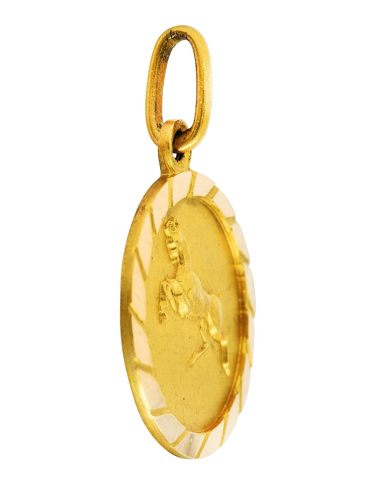 Circular charm has a matte finish and a raised rendering of Aries

Zodiac figure depicted as a stylized ram on its hind legs

Faceted high polish surround

Italian assay marks for 18 karat gold

Circa: 1970's

Measures: 1/2 x 3/4 inch (including