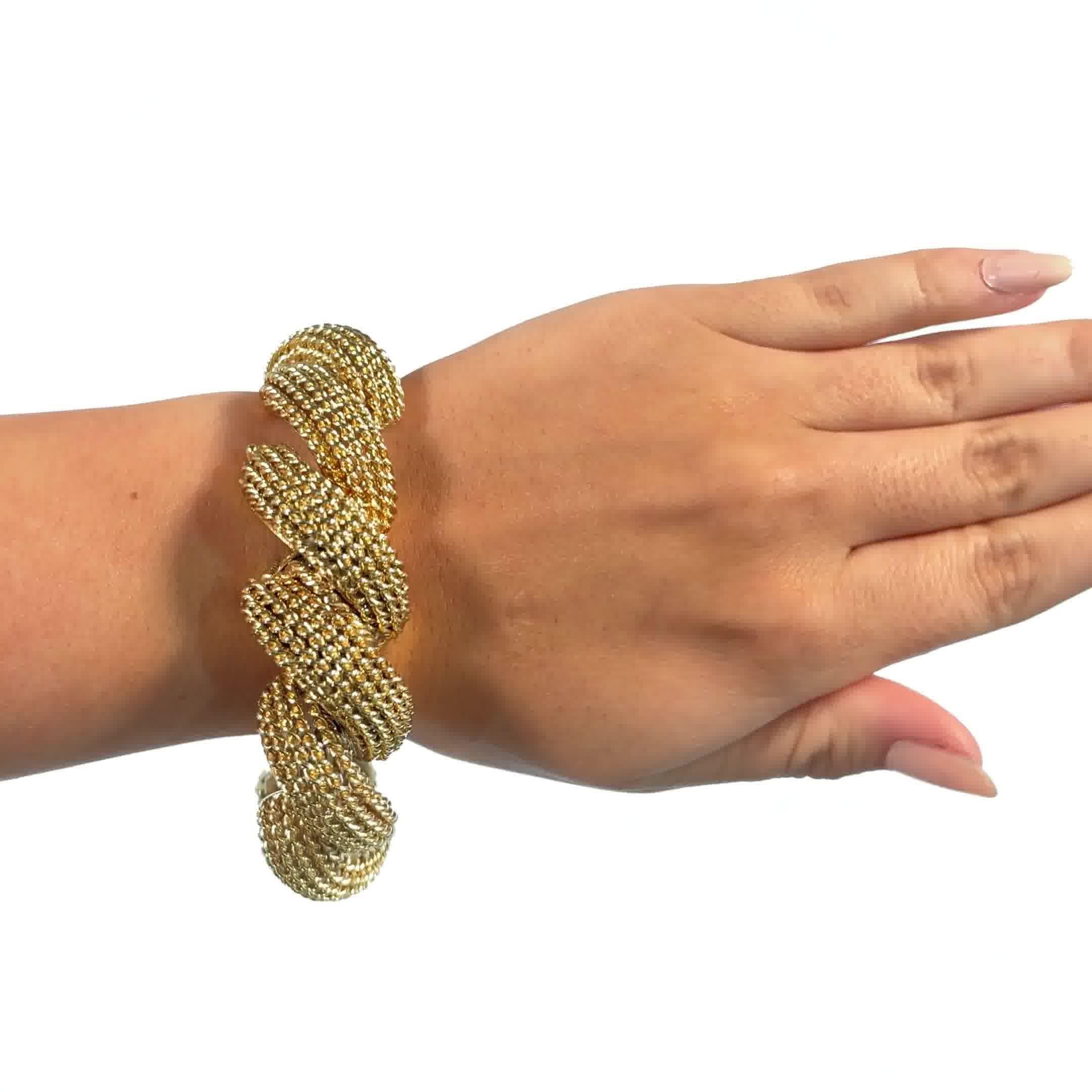 Vintage 18 Karat Yellow Gold Bracelet. The bracelet features a hidden watch. 1950s. 8 inches. 

About The Piece: Do you like a bold gold look? You're in luck because substantial gold pieces are the hottest trend of the new decade. This bracelet is