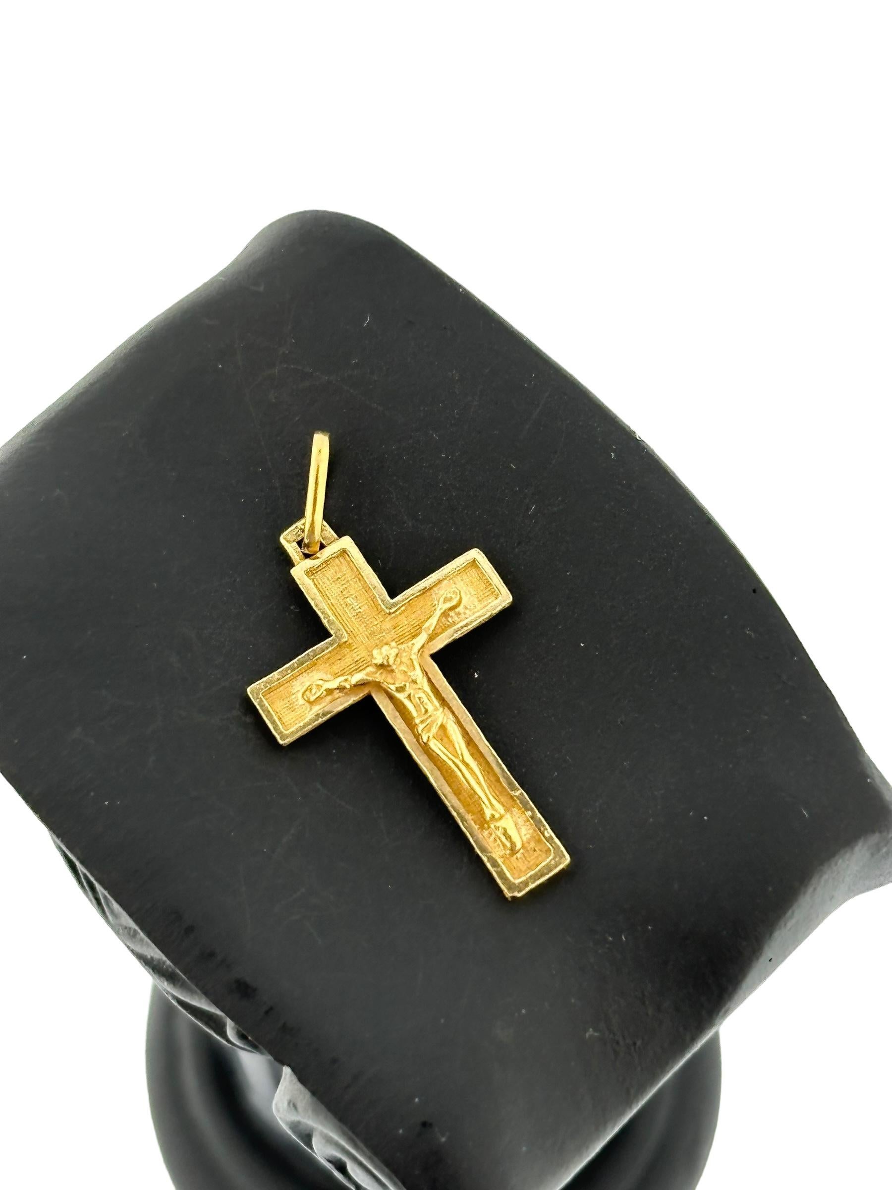 This Vintage 18-Karat Yellow Gold Crucifix is an exquisite piece of jewelry that blends traditional religious symbolism with timeless elegance. Crafted from luxurious yellow gold, this crucifix features a sophisticated satin finish that adds a