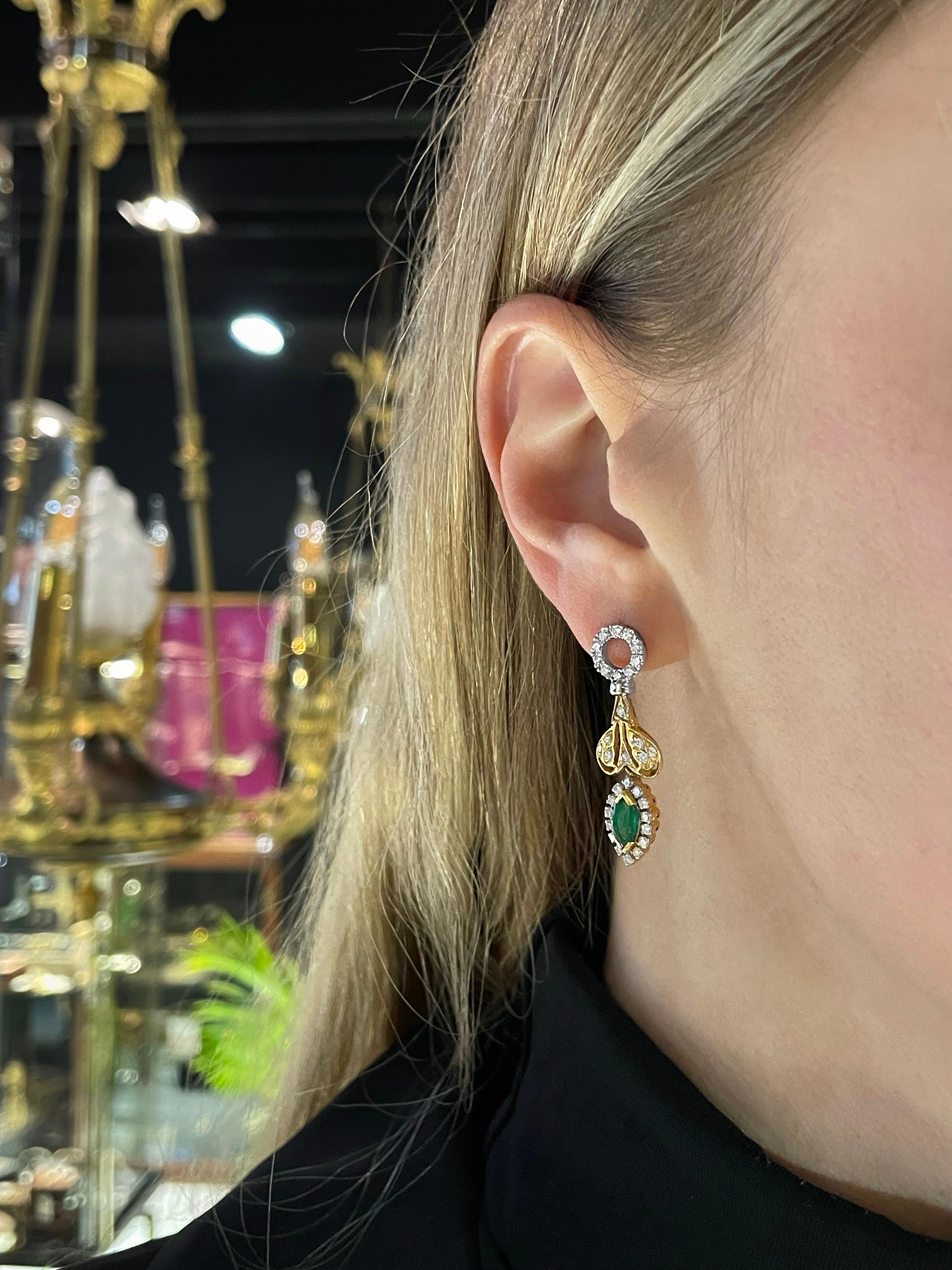 This is a magnificent pair of drop stud earrings crafted in 18K and 14K gold. 

The piece features: 
- 2 marquise cut emeralds: TW 0.90ct, vslbG 6/4, SI-P1
- 42 round brilliant cut diamonds: TW 0.70ct, RW-W, VS-SI

 Has safe “la pousette”