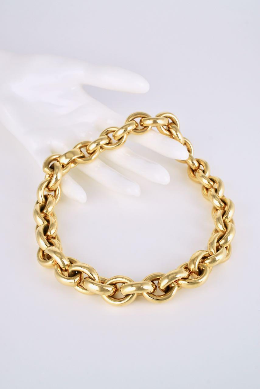 A substantial necklace of 38 links of a tight tubular lens shape link in 18 karat yellow gold finished with an integrated hinged closure - a very desirable choker length necklace that can be worn casually or formally depending on what it is paired