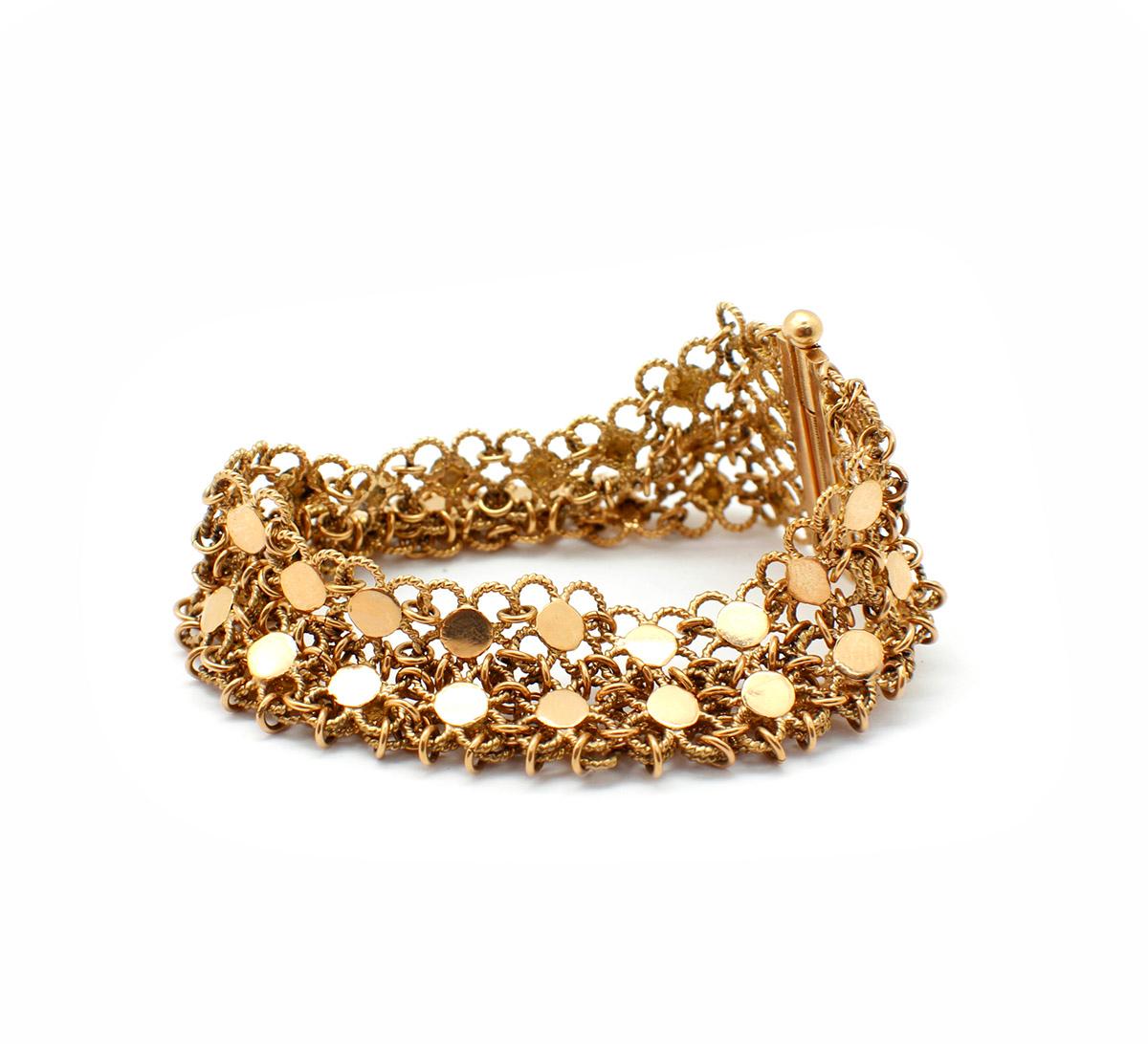 This bracelet is made in 18k yellow gold. It measures 27mm wide, and it will fit up to a 6.75-inch wrist. The piece weighs 41.56 grams.