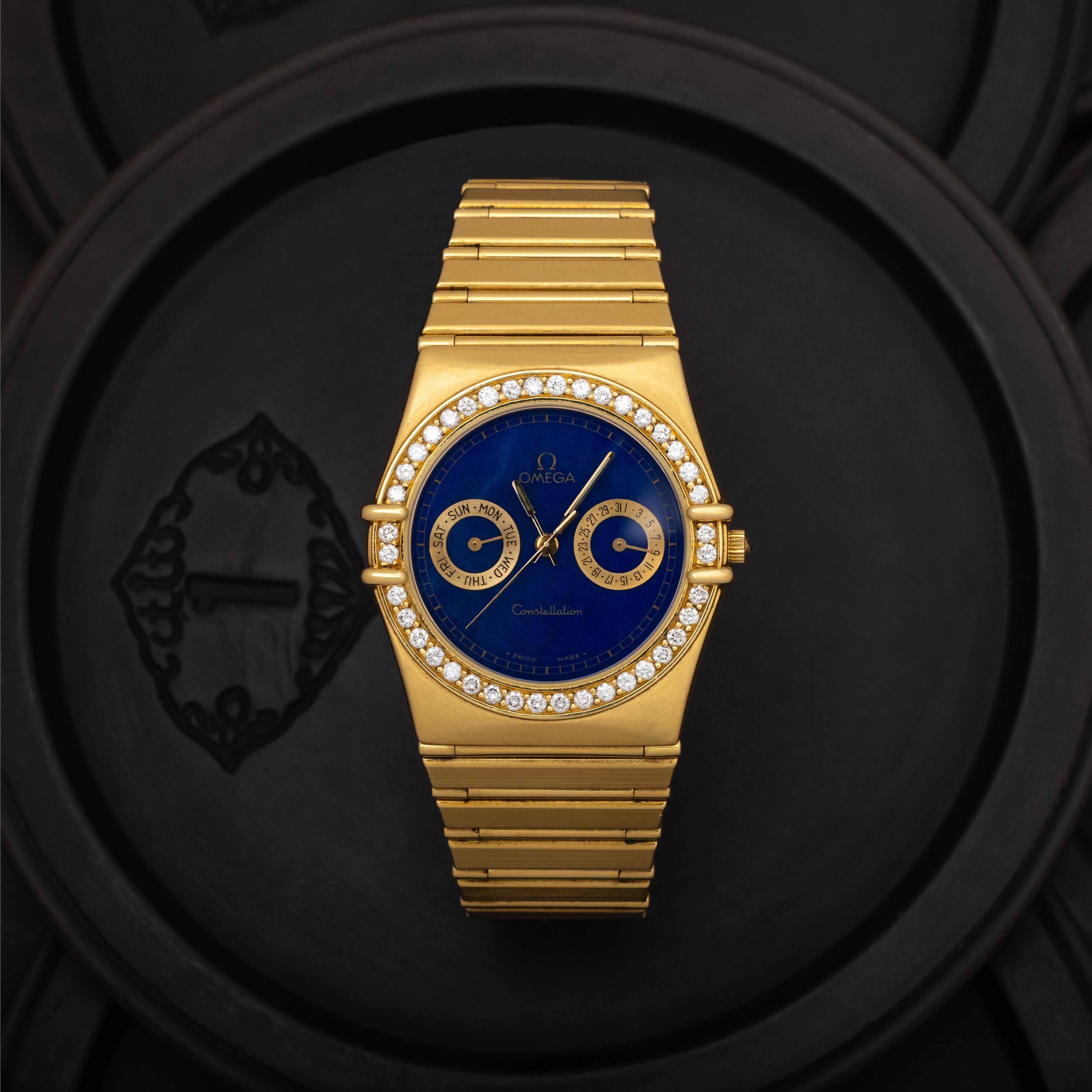Vintage Omega Constellation 
Model
18k Yellow Gold 
34mm Lapis Dial, Diamond Bezel, Model 496.XXXX 
Quartz Movement 
c.1990s 
Made in Switzerland

Stephanie Windsor guarantees the proper functioning of this watch mechanism for ONE year from the