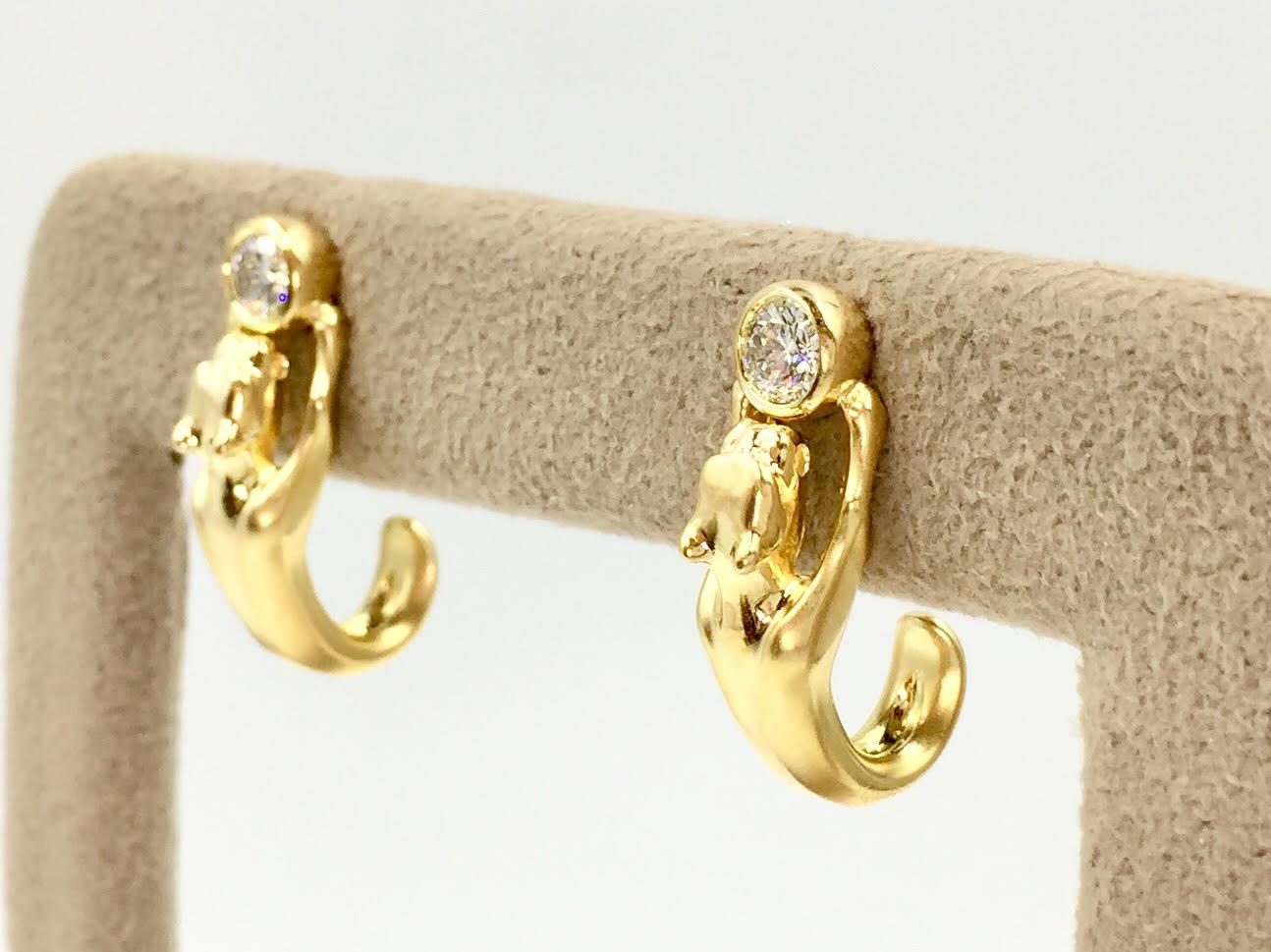 Made with fine craftsmanship, these unusual 18k yellow gold panther cat earrings make a statement while still considered an every day earring. Beautiful satin finish over the body of the panther. Bezel set round brilliant diamonds have a total
