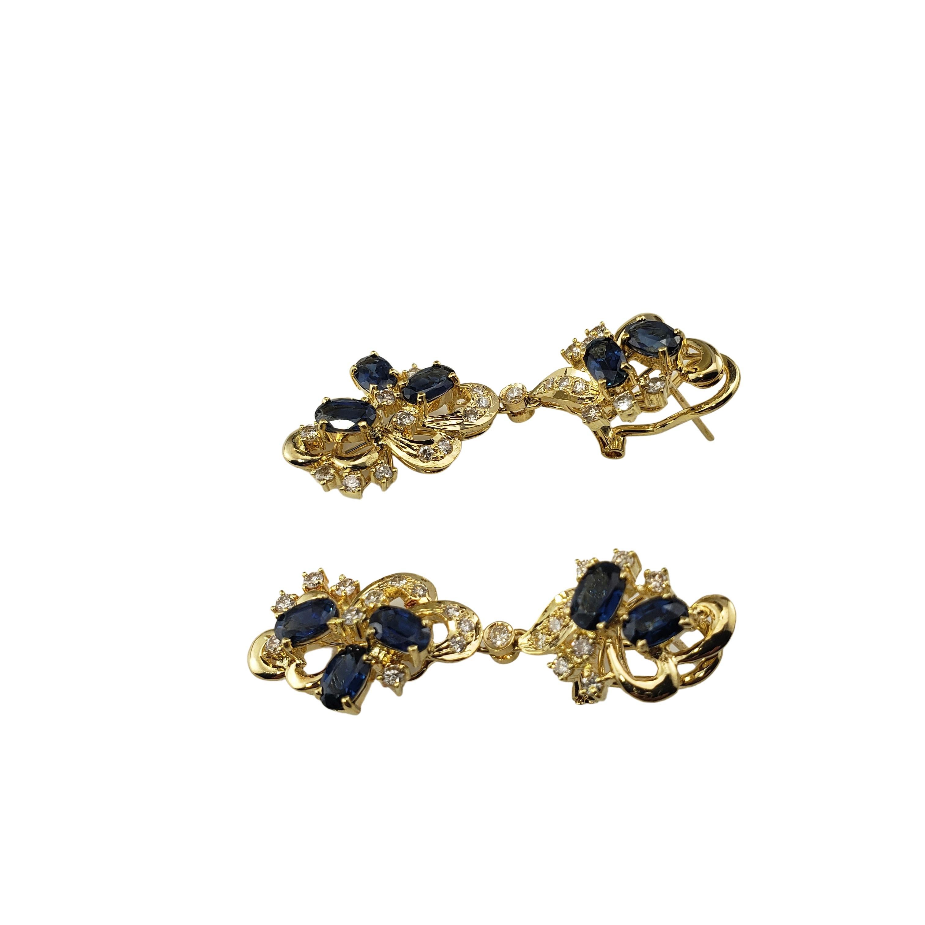Vintage 18 Karat Yellow Gold Natural Sapphire and Diamond Dangle Earrings-

These elegant drop earrings each feature 22 round brilliant cut diamonds and five oval sapphires (approx. 5 mm x 3 mm each) set in beautifully detailed 18K yellow