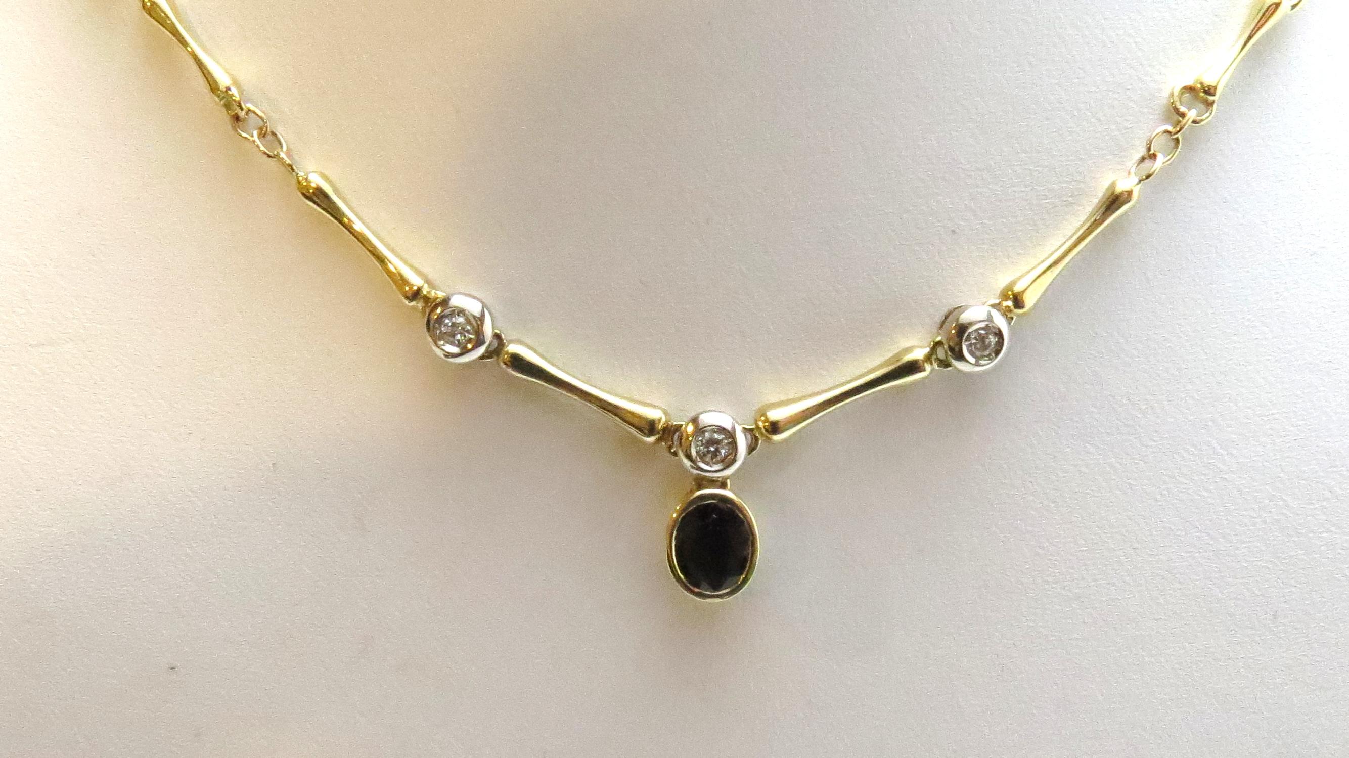Vintage 18 Karat Yellow Gold Sapphire and Diamond Necklace.

This elegant necklace features one oval genuine sapphires (7 mm x 6 mm) accented with three round brilliant cut diamonds on a stunning 18K yellow gold necklace.

Approximate total diamond