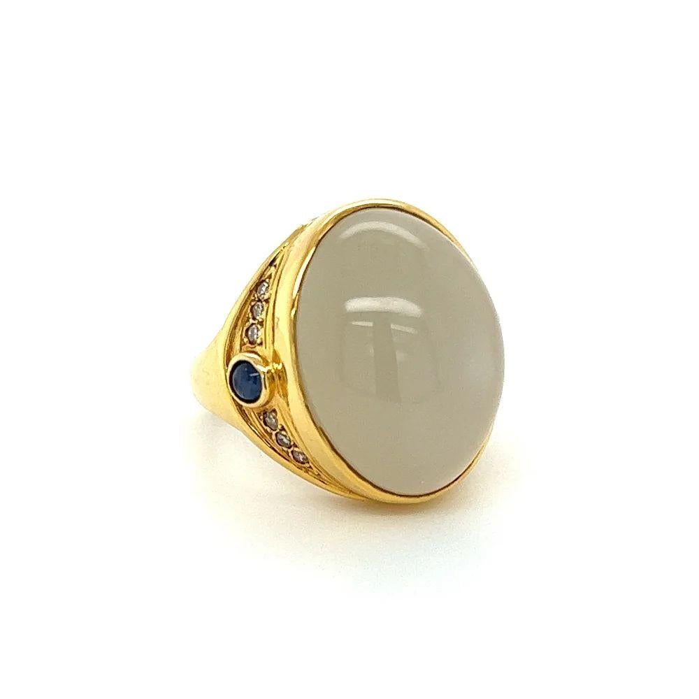 Simply Beautiful! Elegant and finely detailed Moonstone, Sapphire and Diamond Gold Vintage Cocktail Ring. Centering a Fabulous 18.16 Carat Cabochon Moonstone, accented by Sapphires, weighing approx. 0.34tcw and Diamonds approx. 0.13tcw. Hand crafted