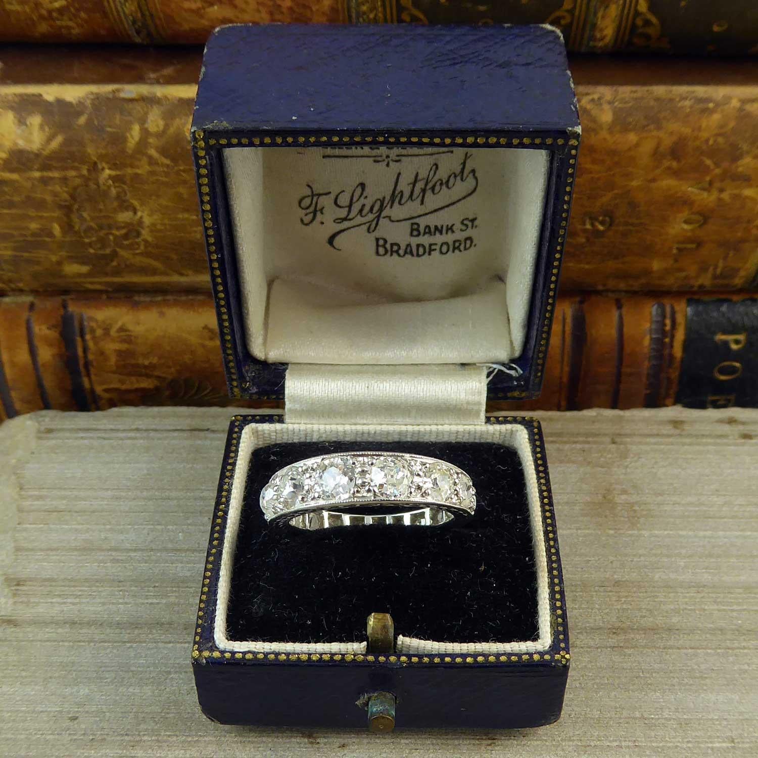 An unusual version of a 1930's/40's wedding or eternity ring.  Normally set with diamonds of the same size this is a little different, and all the nicer for it, by having a row of nine old European cut diamonds graduating in size from approx. 4.37mm