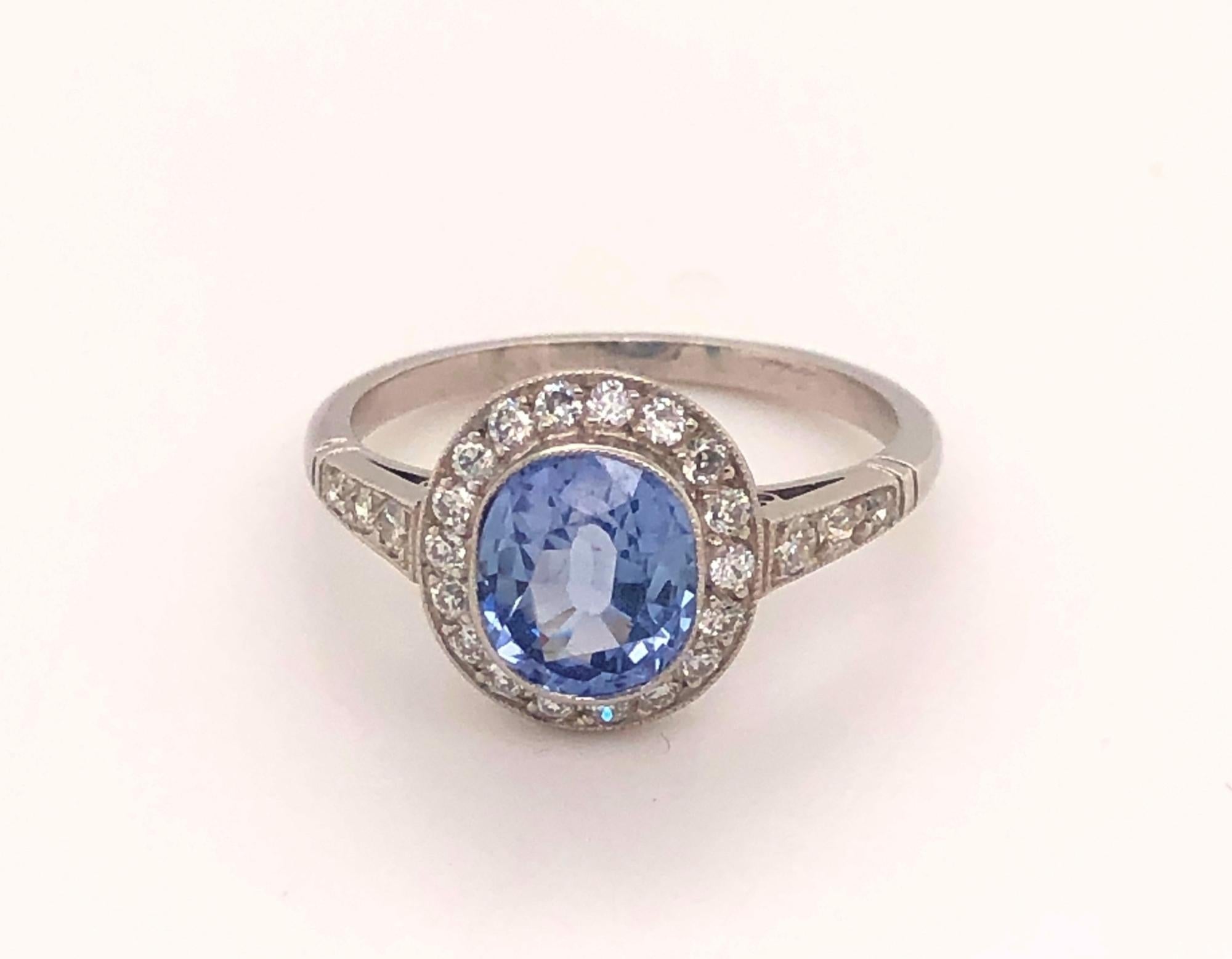 Vintage 1.86 Ceylon Sapphire Diamonds Platinum Halo Ring. This is a beautiful vintage platinum ring set with a natural gem quality 1.86 Ceylon sapphire. The sapphire is oval cut faceted with amazing light blue color. There are 18 diamonds around the
