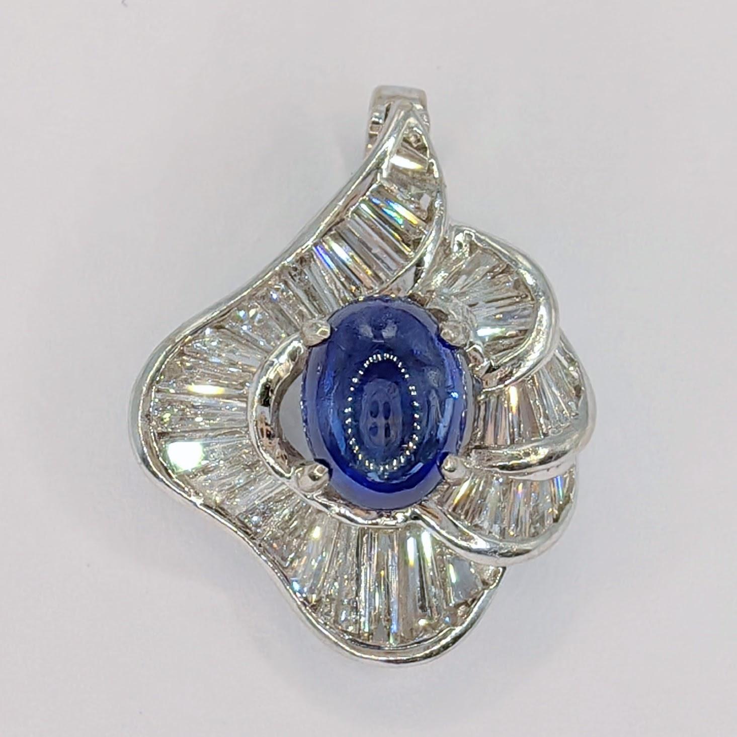 Introducing the Vintage 1.86ct Cabochon Royal Blue Sapphire & Diamond Ballerina Necklace Pendant, a truly mesmerizing piece that exudes elegance and sophistication.

At the heart of this pendant is a stunning cabochon cut Royal Blue Sapphire,