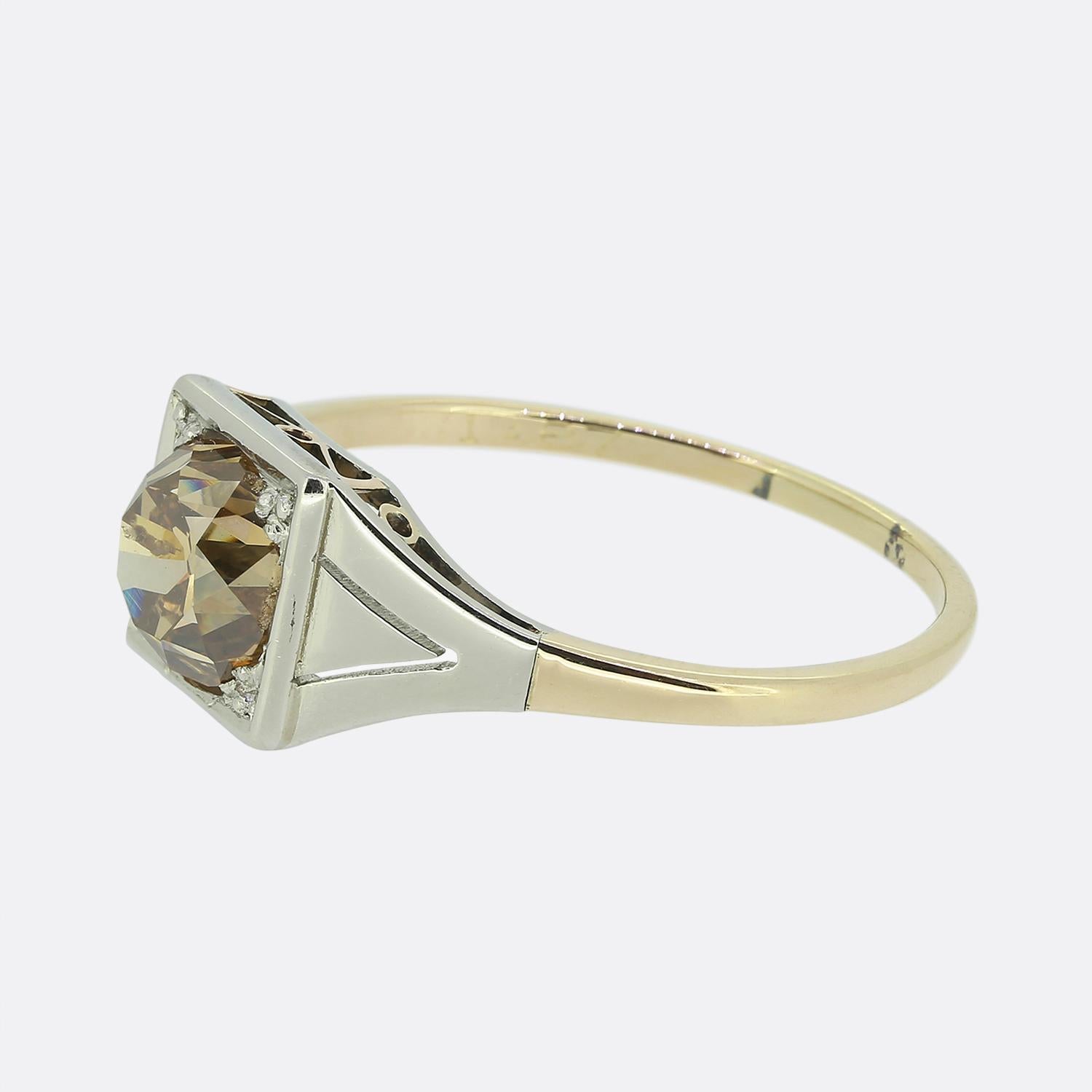 Here we have a vintage 18ct rose gold diamond engagement ring. This lone centralised old mine cut diamond possesses a fancy intense brown colour tone and weighs an impressive 1.87 carats. Although the band of the ring is 18ct rose gold the diamond