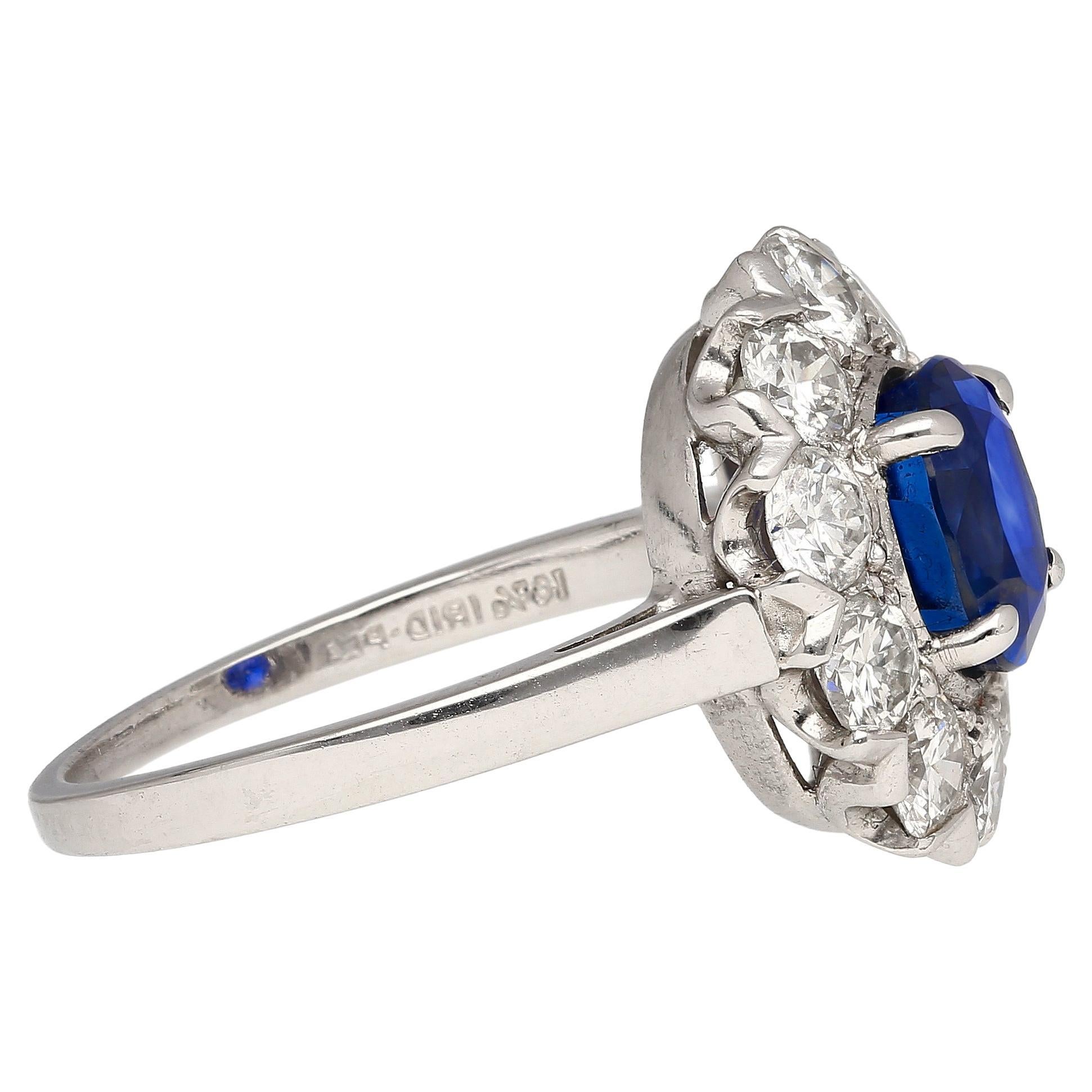 Vintage 1.88 carat Madagascar origin oval cut Blue Sapphire and Diamond halo ring. Set in platinum 900. Circa 1940, likely from the Art Deco to Retro Era. Adorned with a 10 round-cut diamond halo. A ring that exudes opulence and refinement. The