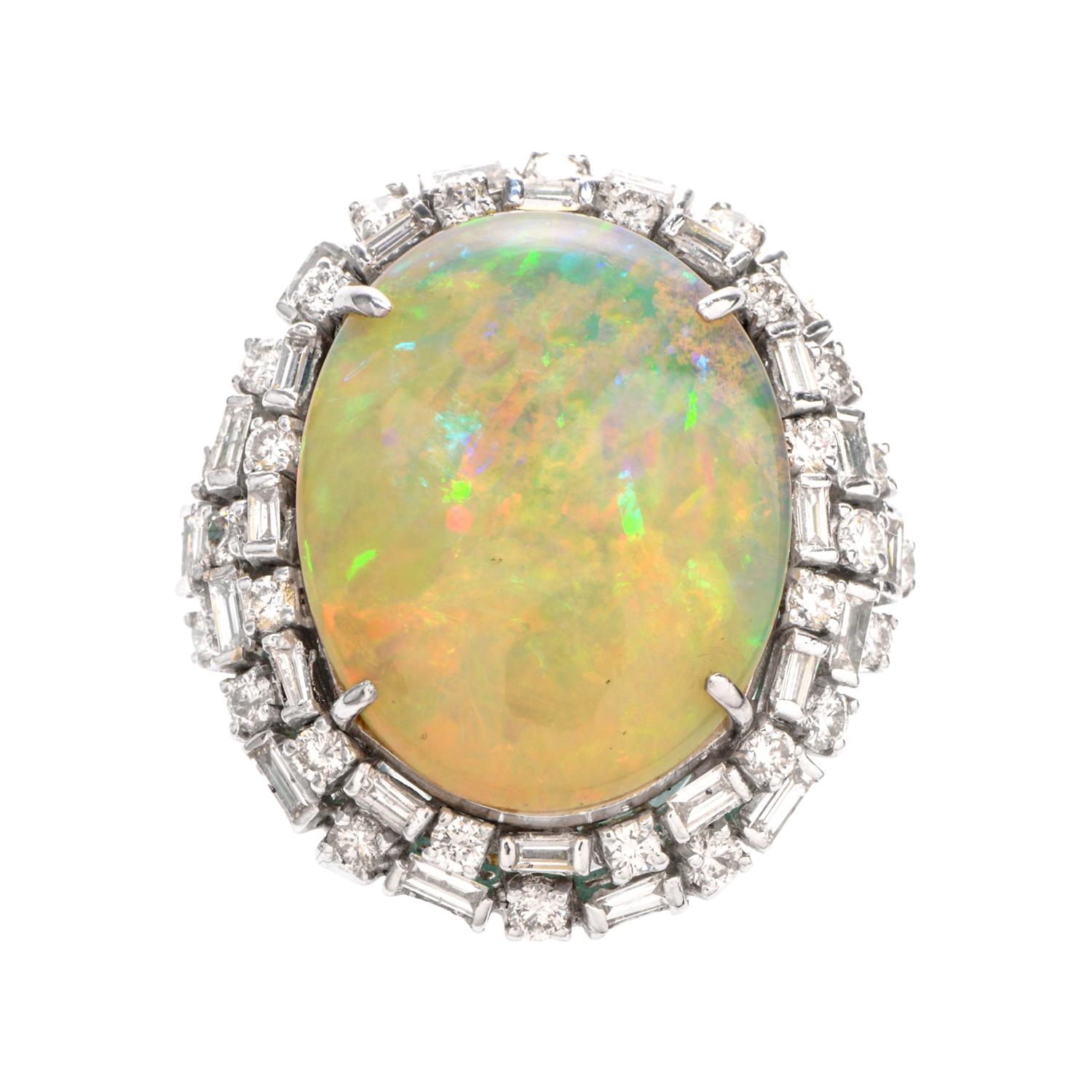This eye-catching cocktail ring boasts color with a large oval-shaped

fiery Opal offering bursts of red, green, and blue.

With the Opal measuring appx. 21.90mm x 17.36mm x 8.63 mm and weighing

appx. 18.81 carats, this piece is surrounded by a