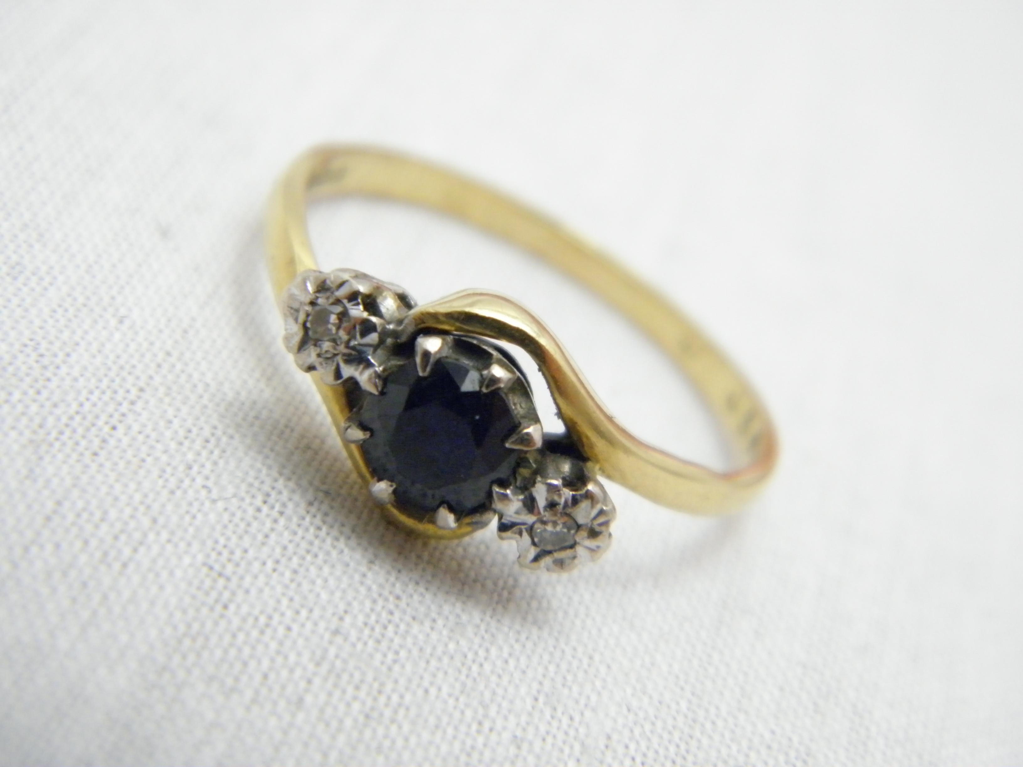 If you have landed on this page then you have an eye for beauty.

On offer is this gorgeous
18CT GOLD SAPPHIRE DIAMOND BYPASS TRILOGY ENGAGEMENT RING

Crafted from solid 18ct Yellow Gold (750/000) with a White Gold mount
and fully assay marked in