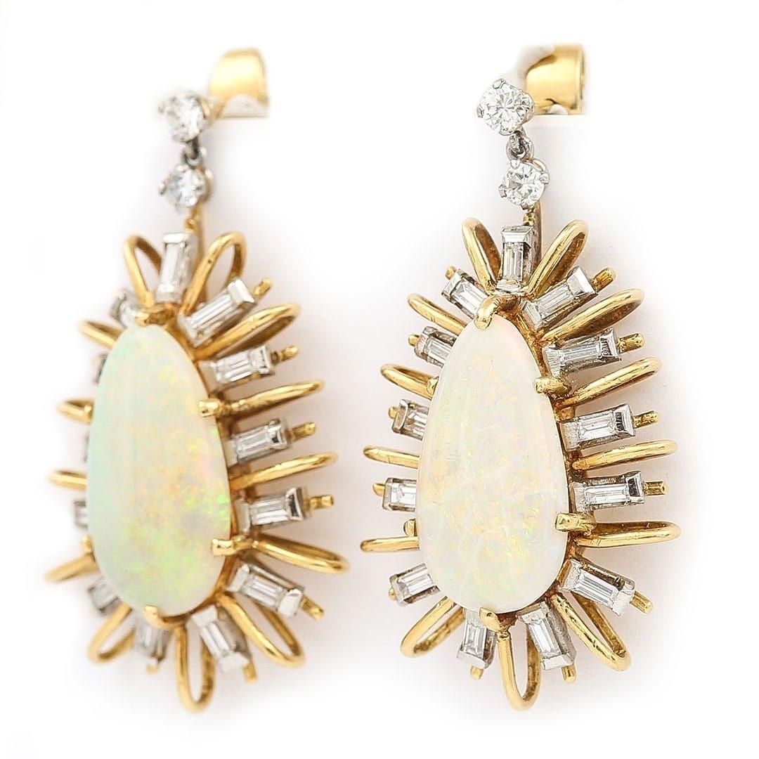 A superb pair of large star-burst design 18ct gold precious opal and diamond earrings of impressive proportions hand crafted circa 1960. The pear shaped opals showing beautiful hues of electric blue, neon green, red and yellow. With and estimated