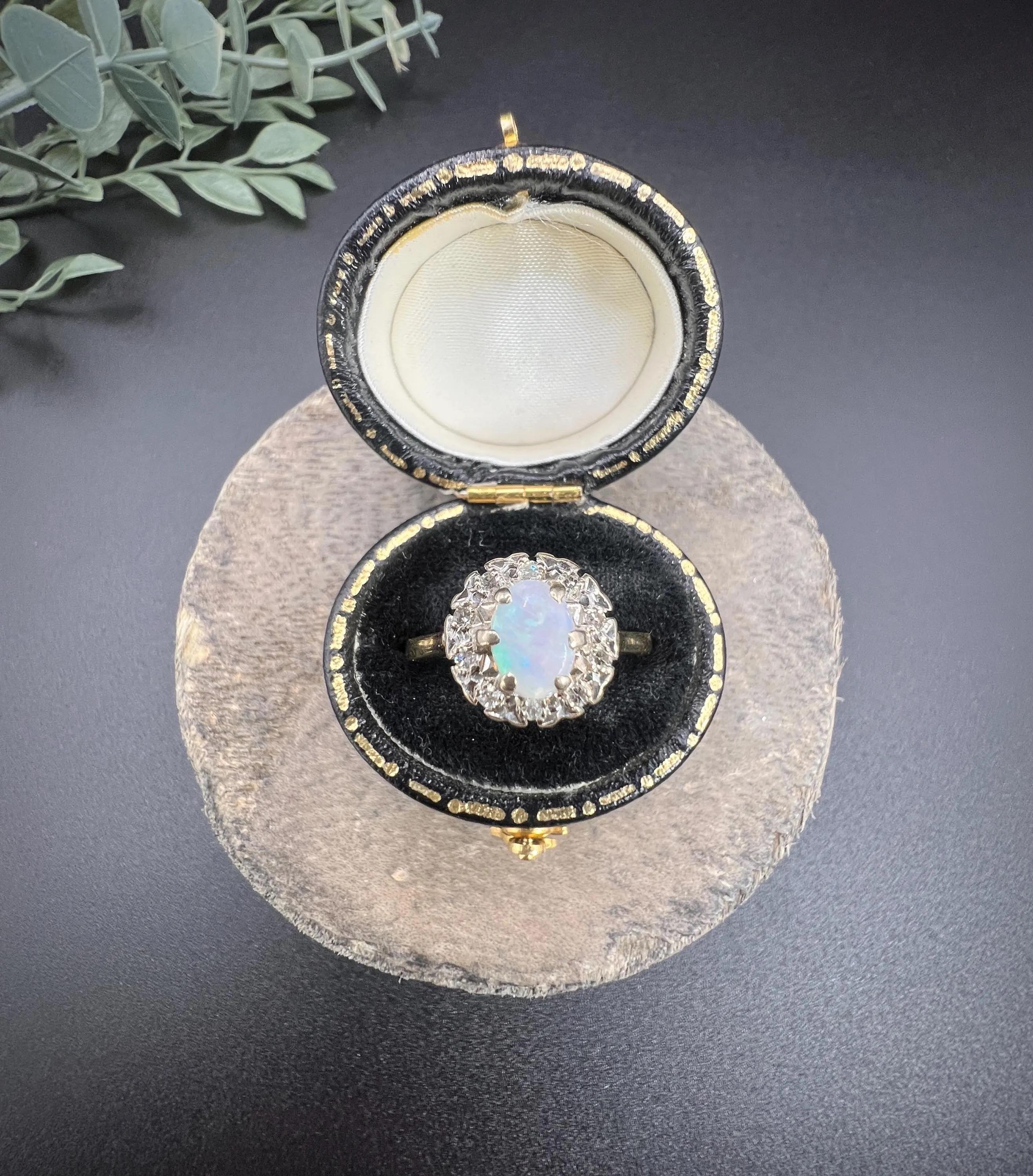 Vintage Opal Cluster Ring 

18ct Gold 

Hallmarked London 1970

Step back in time with this exquisite vintage 1970s cluster ring, a true statement piece that captures the elegance of a bygone era. At the heart of this stunning ring is a captivating