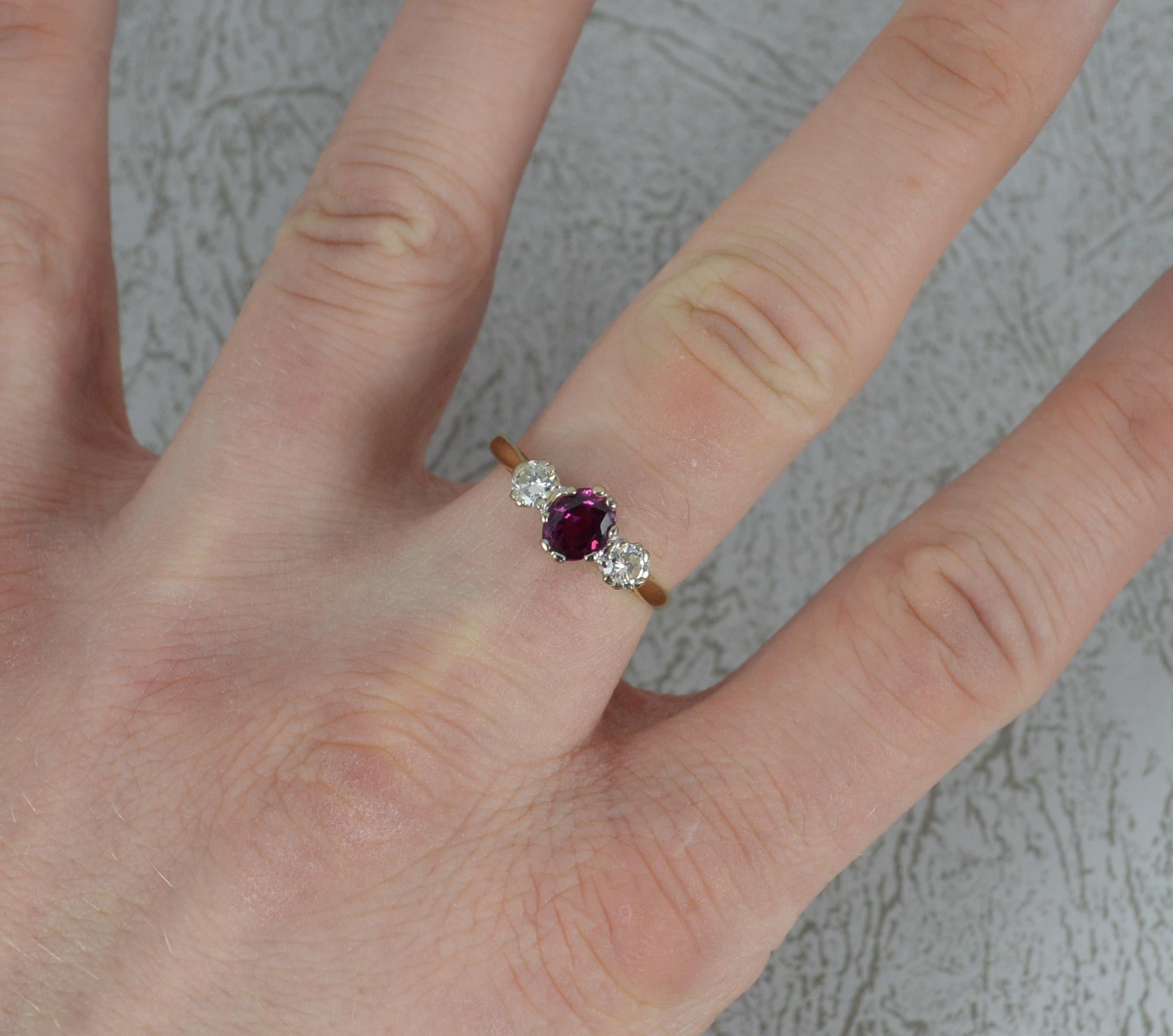 A superb Ruby and Diamond ring, circa 1940.
18 carat yellow gold shank and platinum double claw setting.
Designed with a very vibrant natural oval ruby to centre with a vs diamond to each side. 5mm x 6mm ruby. 0.2 carat diamond to each side.
13.2mm