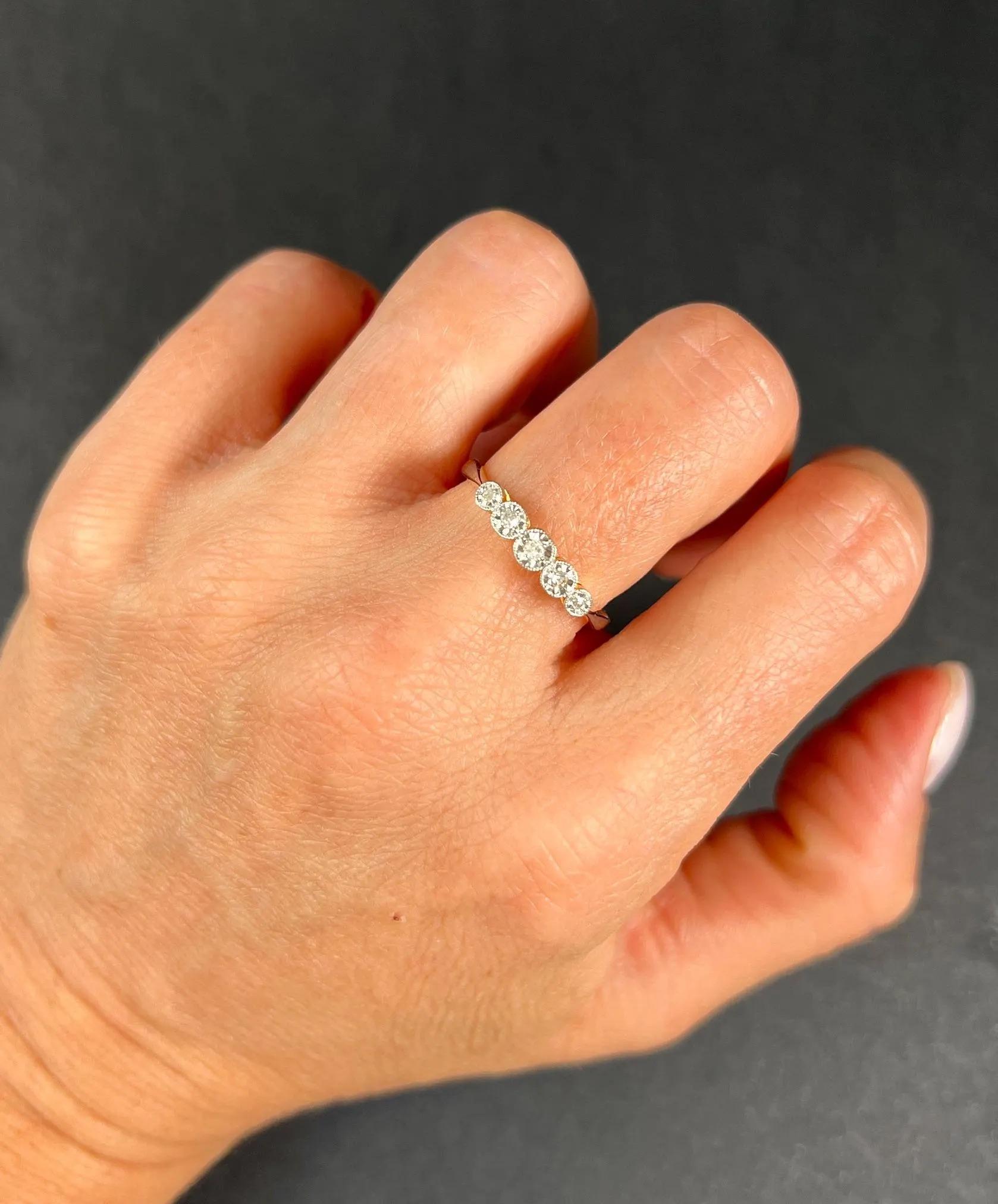 Vintage Diamond Ring 

18ct Gold & Platinum Stamped 

Makers Mark H S

Check out this stunning 18ct gold vintage engagement ring. This exquisite ring showcases five milgrain-set natural diamonds, each elegantly placed in round platinum illusion