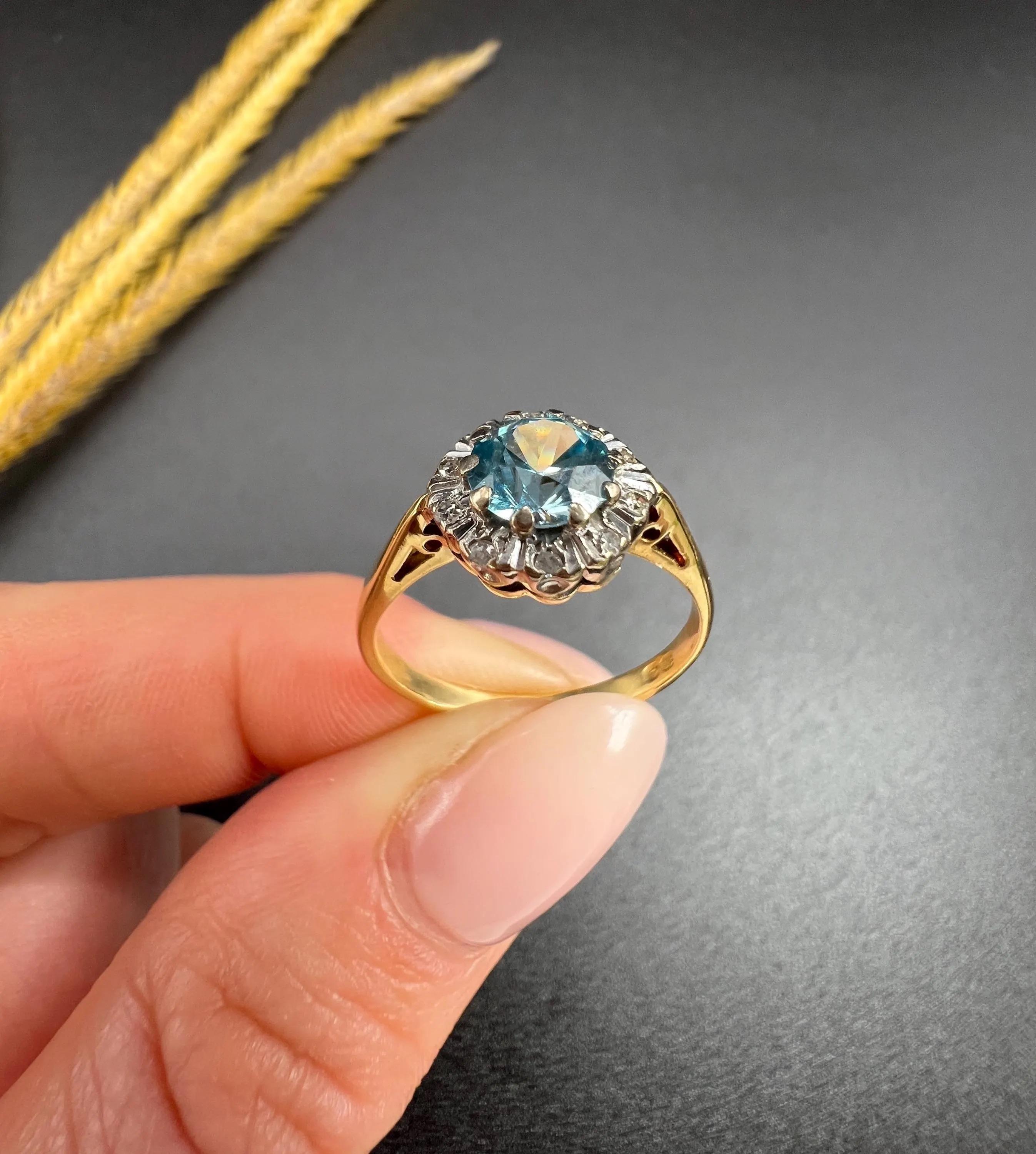 Antique Zircon & Diamond Ring 

18ct Gold

Circa 1960s

This stunning vintage cluster ring from the 1960s features a beautiful zircon centre and a fabulous halo of natural diamonds. It is mounted on an 18ct yellow-gold, reverse tapered band, making