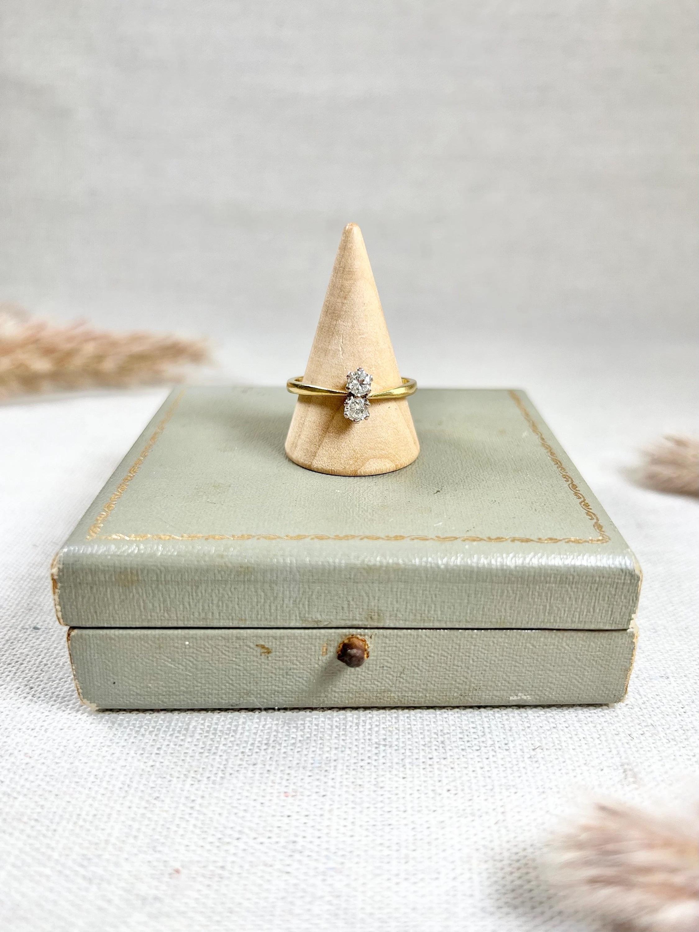 Vintage Diamond Ring 

18ct Gold Stamped

Hallmarked Birmingham 1998

Makers Mark EXF 

This stunning 18ct yellow gold toi et moi ring is a vintage piece that exudes timeless elegance. The ring is stamped with an 18ct gold mark and features a