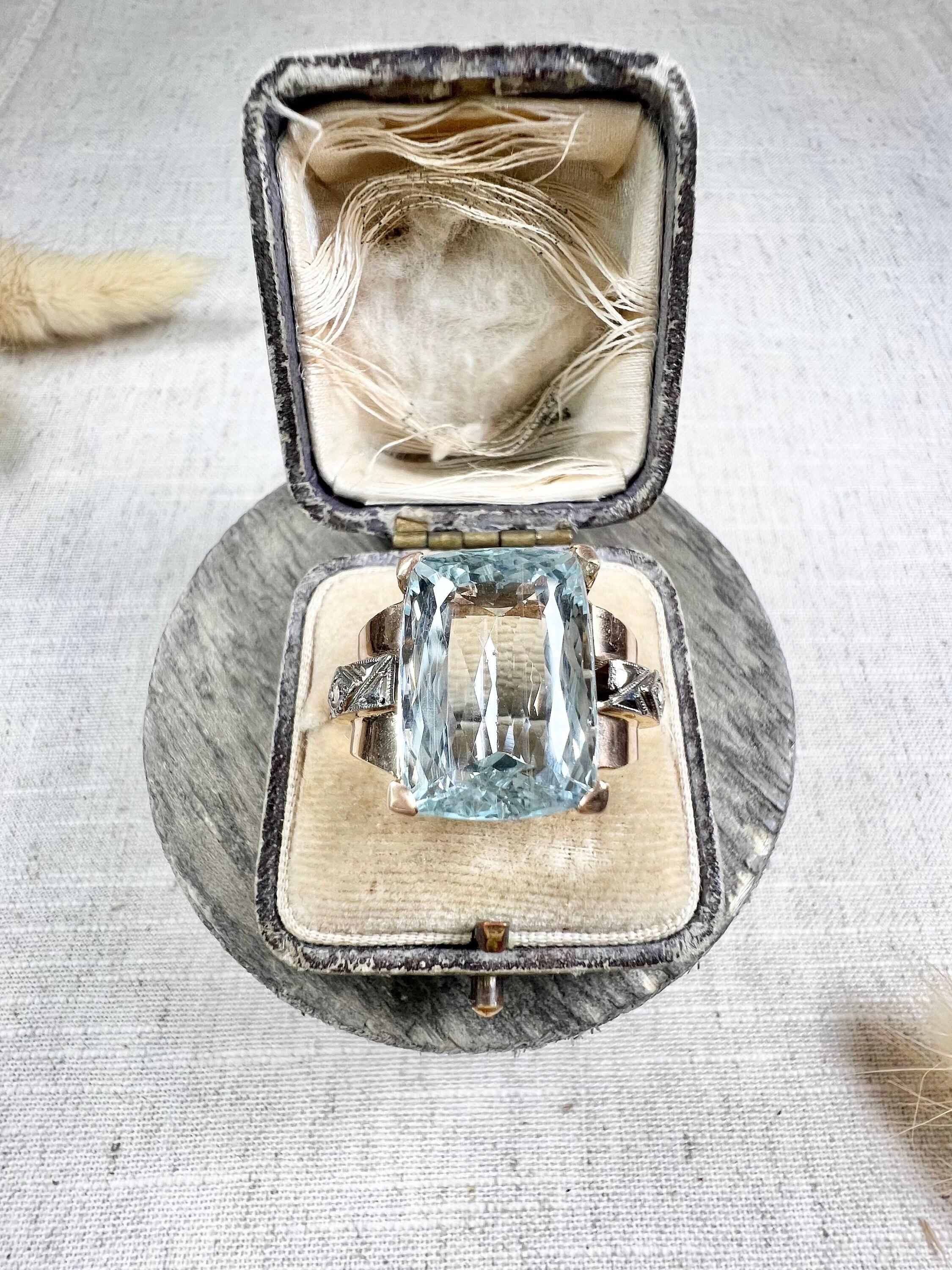 Vintage Aquamarine Cocktail Ring 

18ct Rose & White Gold Tested 

Circa 1940’s

Introducing a stunning 1940s 18ct gold cocktail ring that exudes timeless elegance and sophistication. This exquisite ring features a magnificent large cushion-cut,
