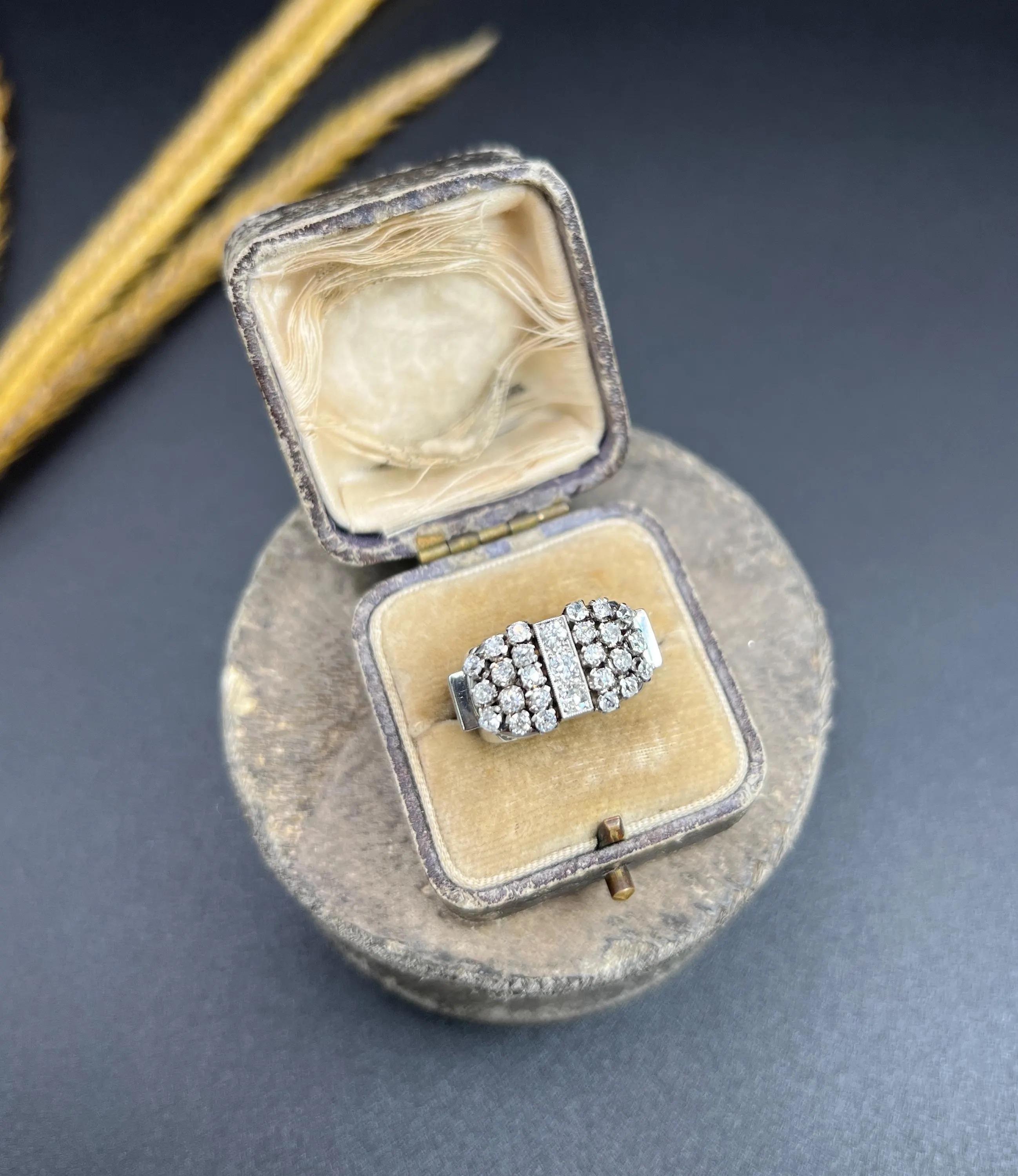 Vintage Cocktail Ring 

18ct White Gold

Circa 1960s

Step back into the elegance of the 1960s with this exquisite tank-style cocktail ring crafted in 18ct white gold. The ring showcases a striking design, featuring three milgrain-set diamonds
