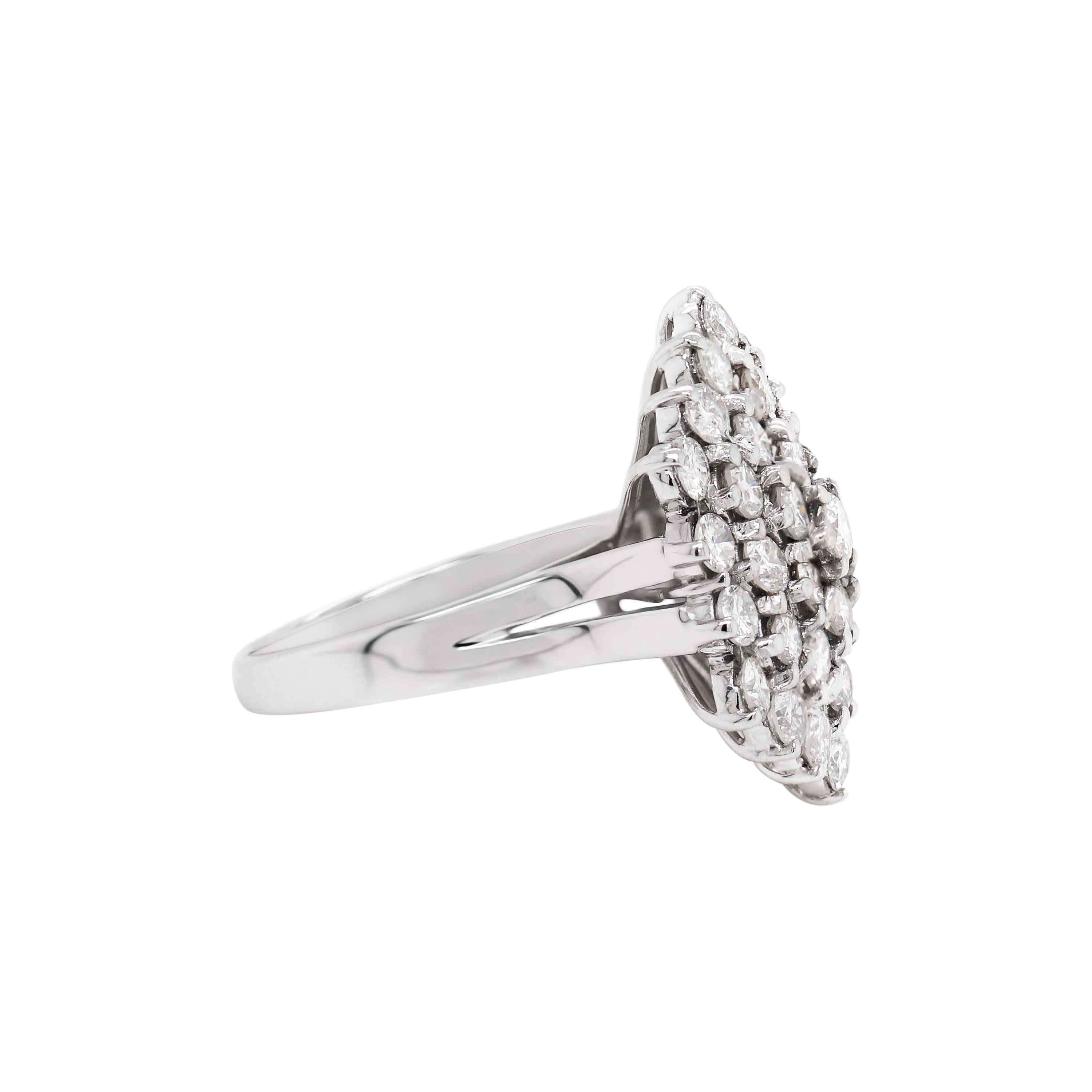 This impressive dress ring features 37 round brilliant cut diamonds all mounted in a hexagonal shaped mount, weighing approximately 4.00ct, claw set in open back settings. The diamonds sit above a fine 18 carat white gold shank. Hallmarked, England