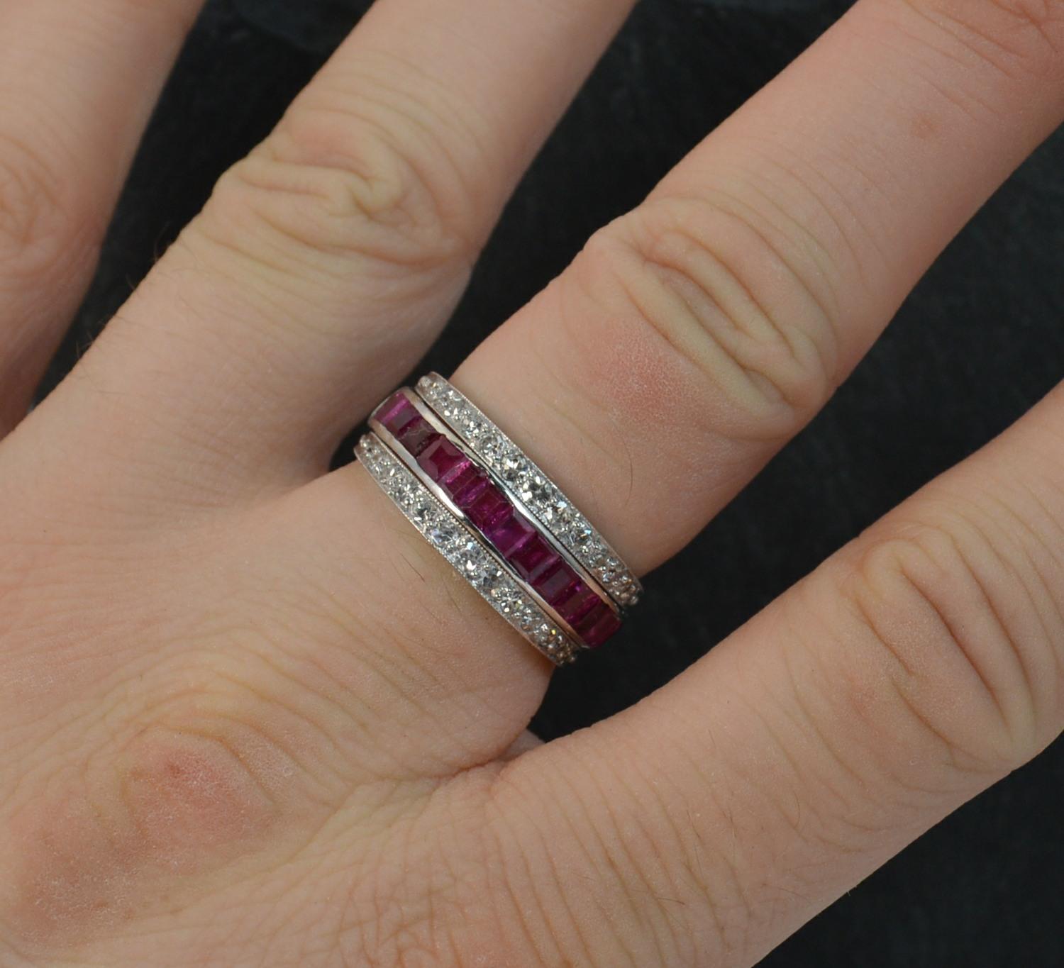 A stunning Day / Night ring c1940.
SIZE ; N UK, 6 3/4 US
Solid 18 carat white gold example.
Designed with the central band of princess cut rubies to one half and plain gold the other. There are two hinged sections with round eight cut diamonds, one