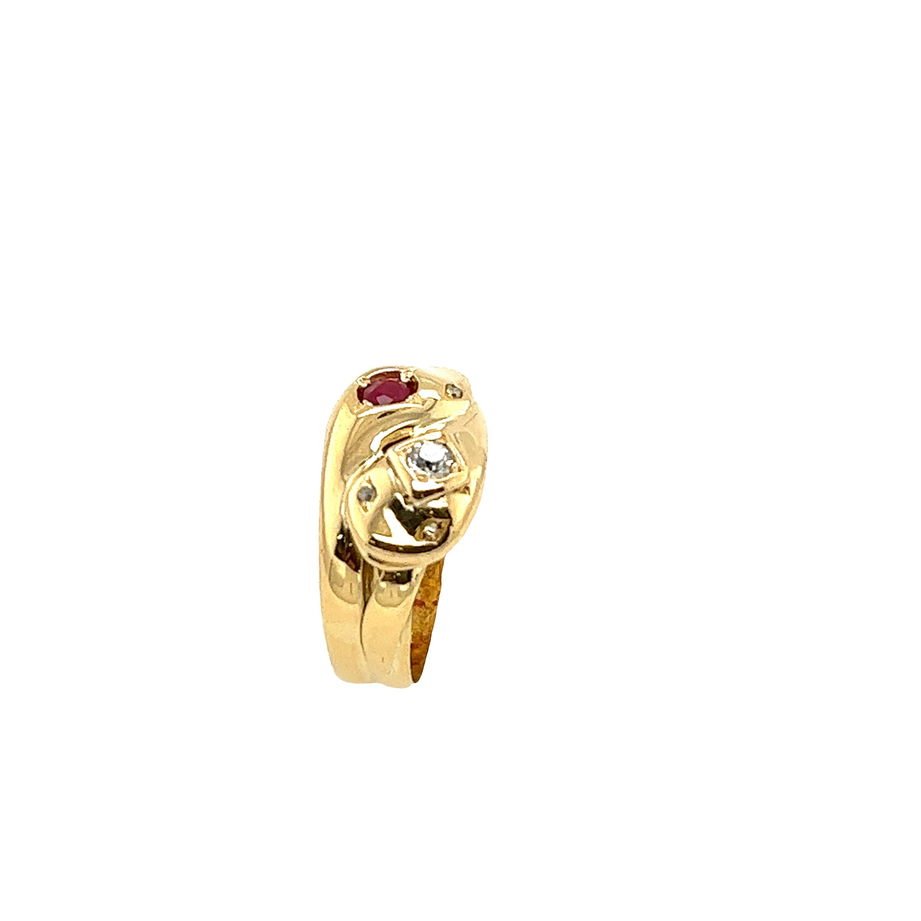 Vintage 18ct Yellow Gold Diamond & Ruby Ring, set in a double snakes head design with 0.10ct natural diamonds, and a round Ruby. 
There are also 4 old Victorian cut diamonds used for the 
snakes eyes. This ring is unique and perfect for wearing