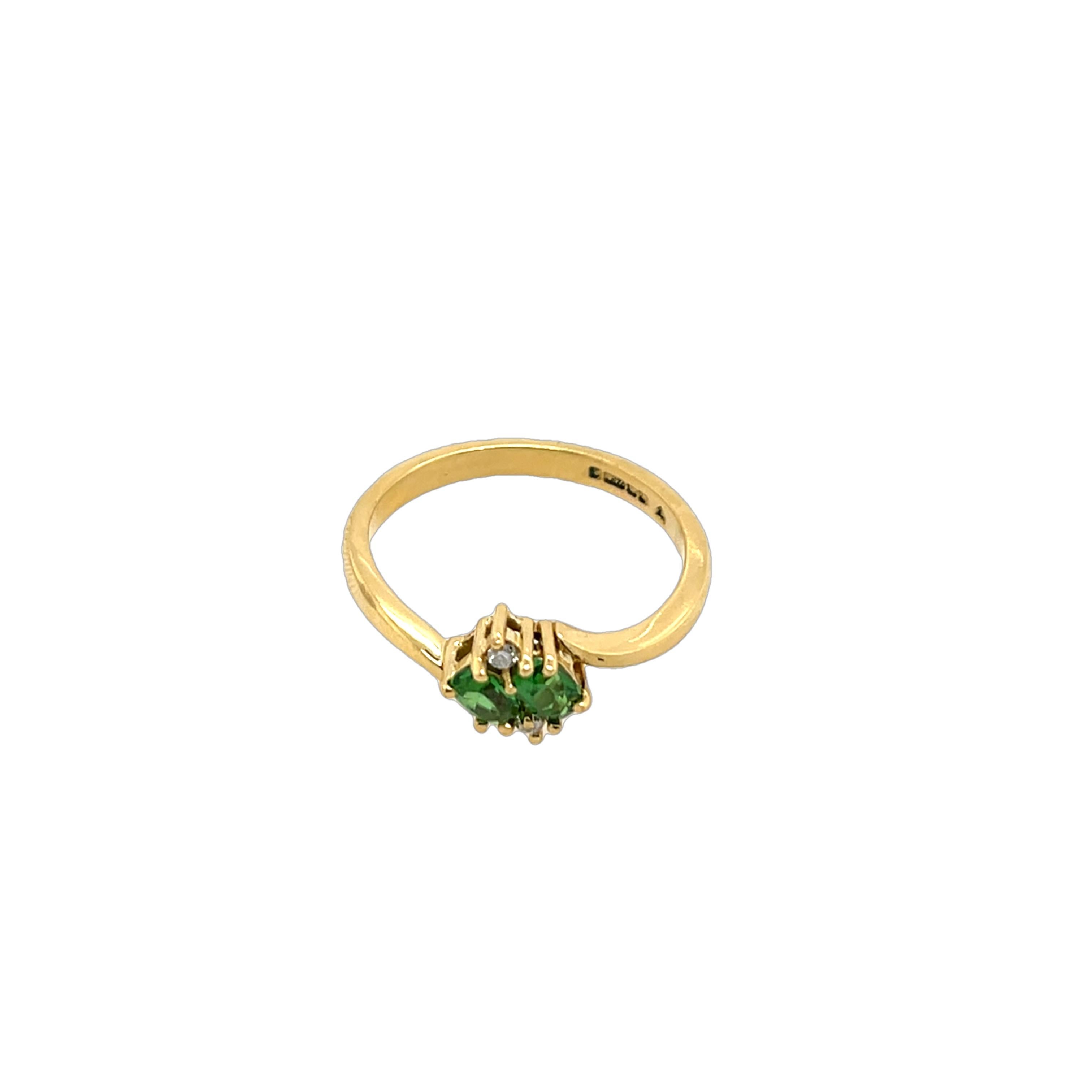 This stunning vintage 18ct yellow gold ring 
showcases a beautiful combination 
of brilliant-cut diamonds and vivid green tsavorite garnets, 
set in an elegant and timeless design. 

Total Diamond Weight: 0.03ct
Diamond Colour: H
Diamond Clarity: