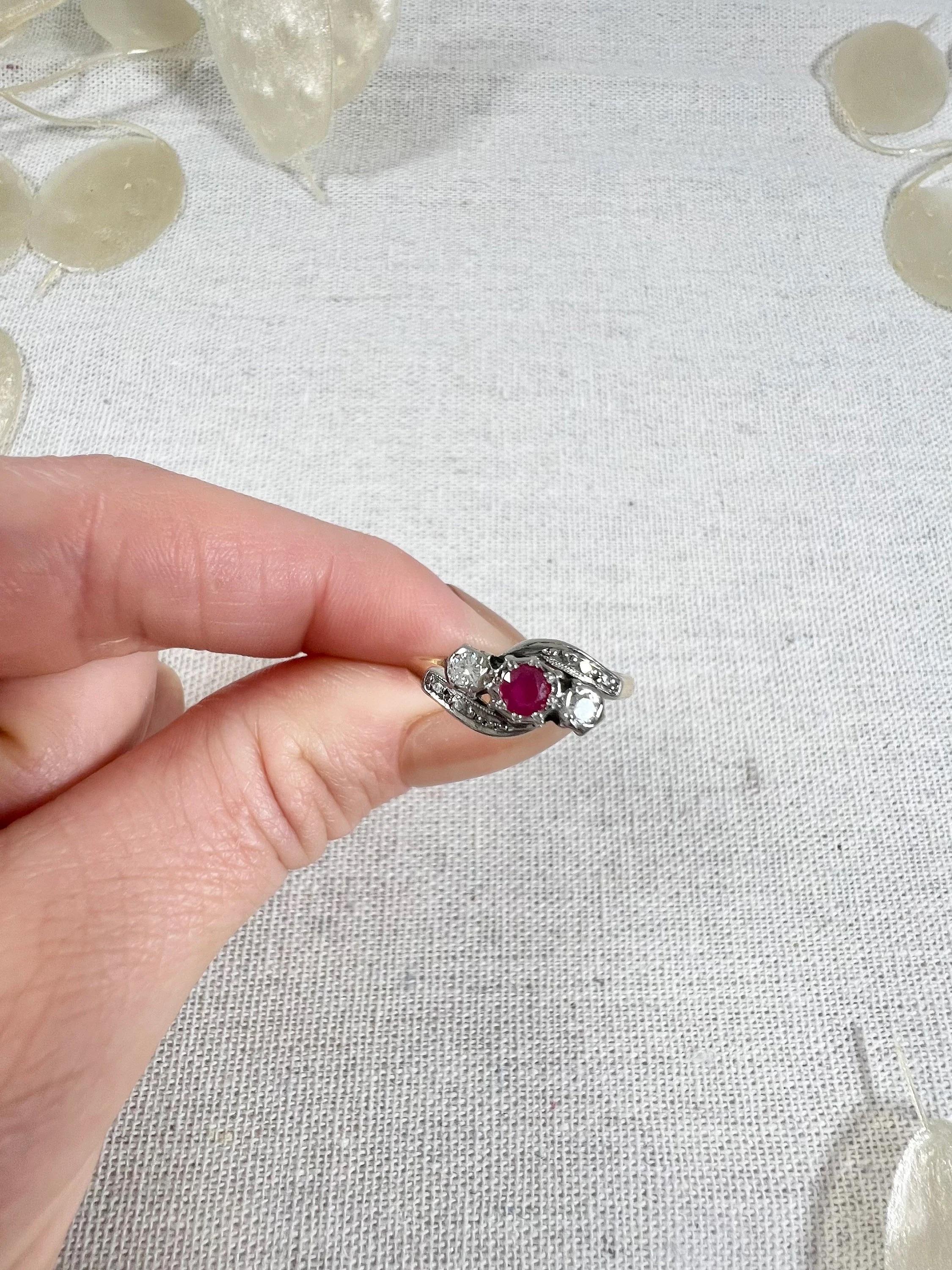Antique Ruby & Diamond Ring 

18ct Gold & Platinum Stamped

Circa 1940s

This exquisite vintage ring from the 1940s features a stunning combination of 18ct yellow gold and platinum. The centrepiece of the ring is a beautiful three-stone crossover